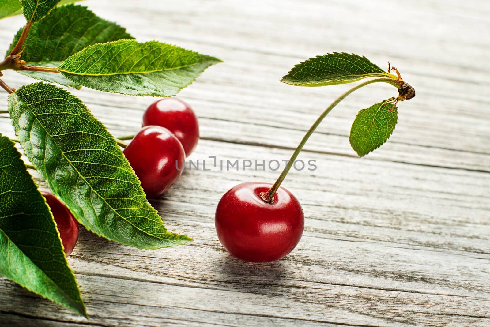 Fresh red cherries on wooden table close up