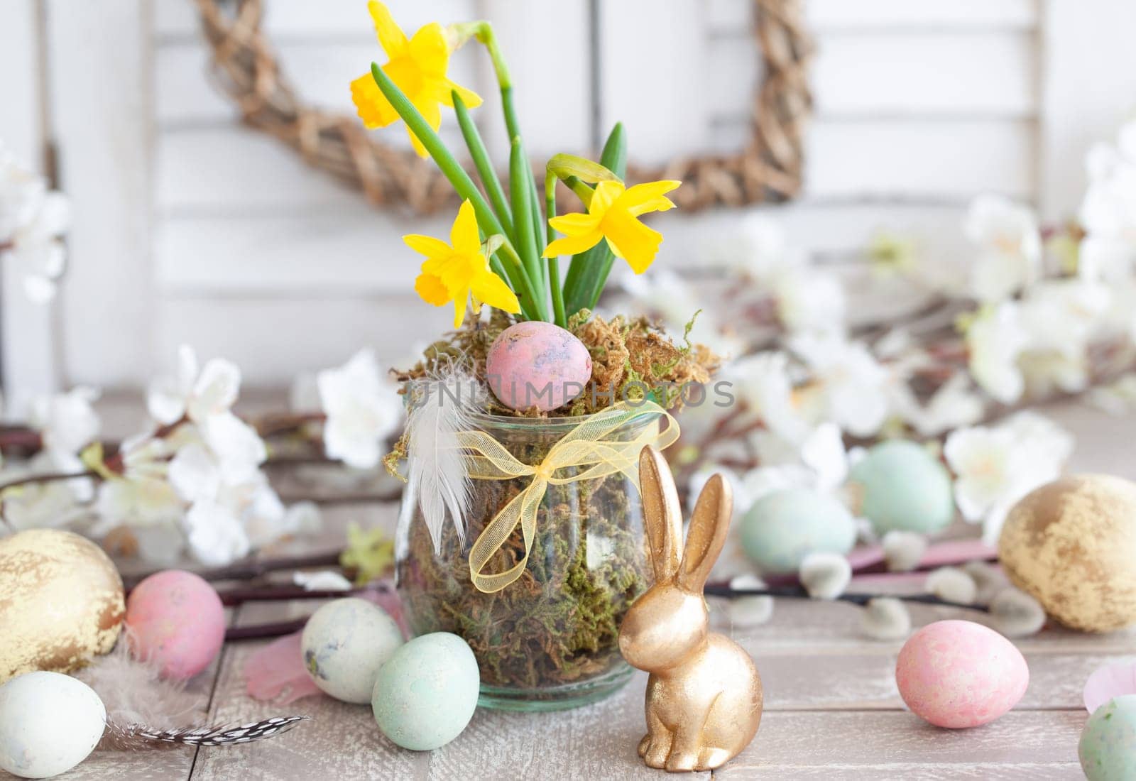 Freah daffodils and colorful eggs for a happy easter