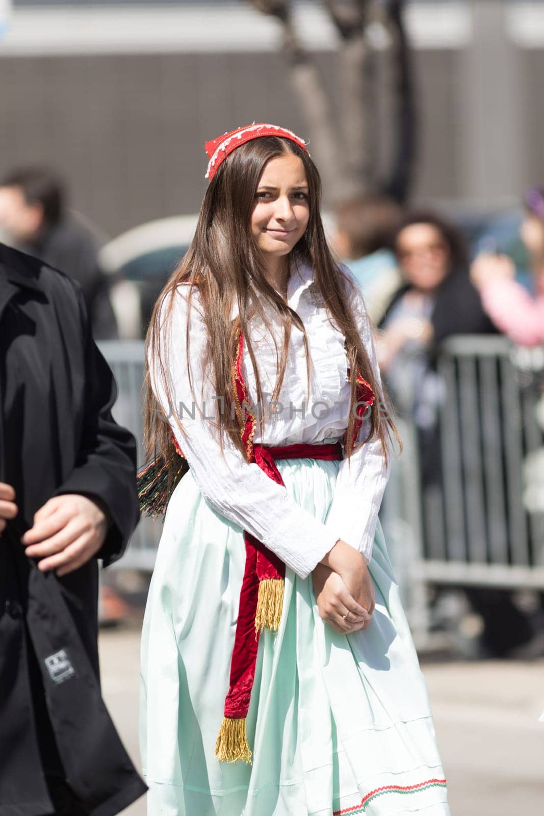 Chicago, Illinois, USA - April 29, 2018  A young Greek woman wearing traditional clothing during the Greek Independence  Day Parade