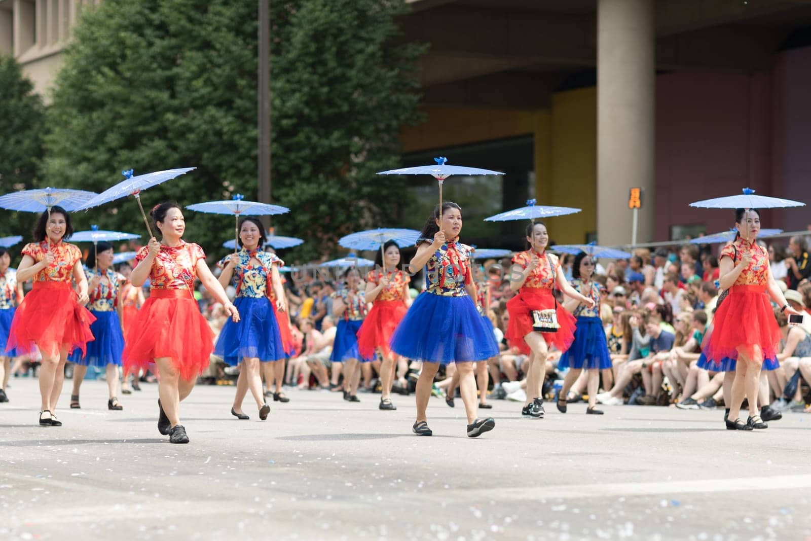 Indianapolis, Indiana, USA - May 26, 2018, Women wearing traditional chinese clothing and holding umbrellas from the Confucius Institute Indianapolis, from the IUPUI University  at the Indy 500 Parade
