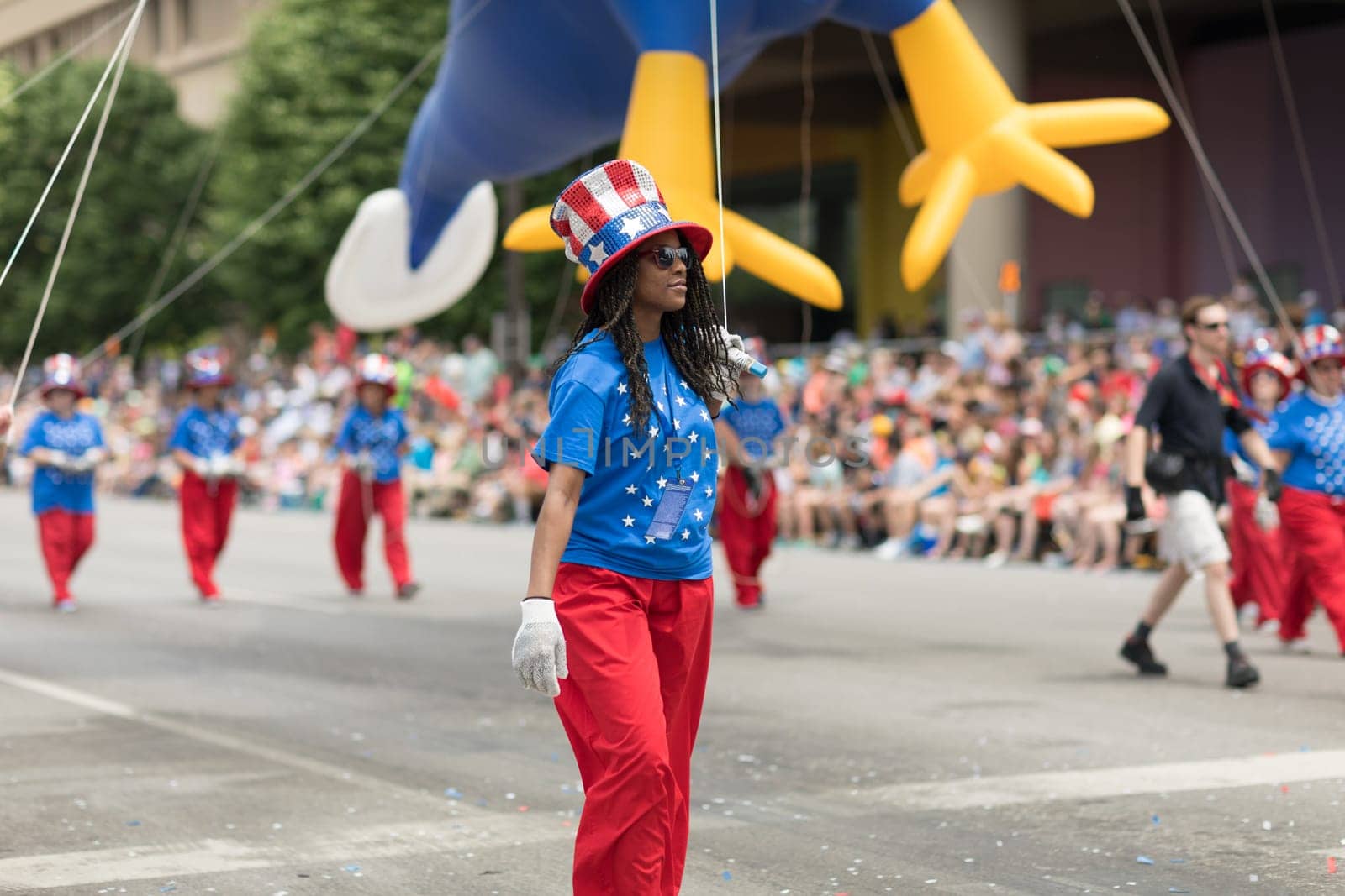 Indianapolis, Indiana, USA - May 26, 2018,  Men and women wearing clothing with the colors of the american flag holding a balloon at the Indy 500 Parade