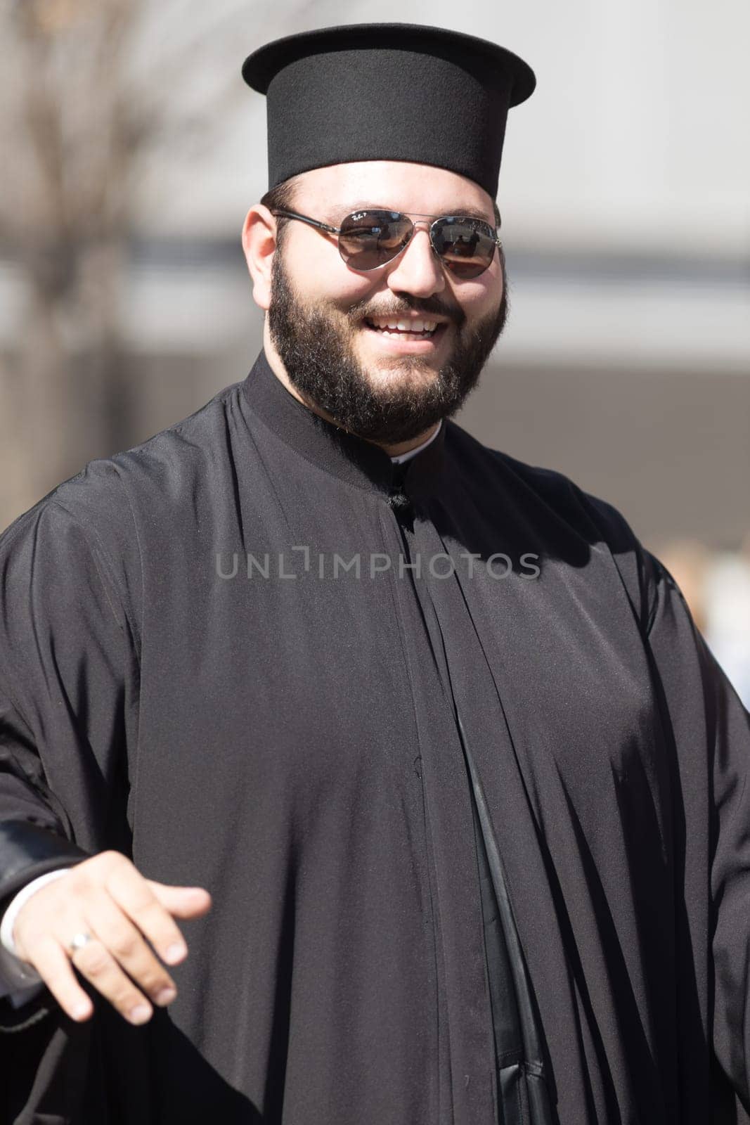 Chicago, Illinois, USA - April 29, 2018 An orthodox priest smiles at the Greek Independence  Day Parade