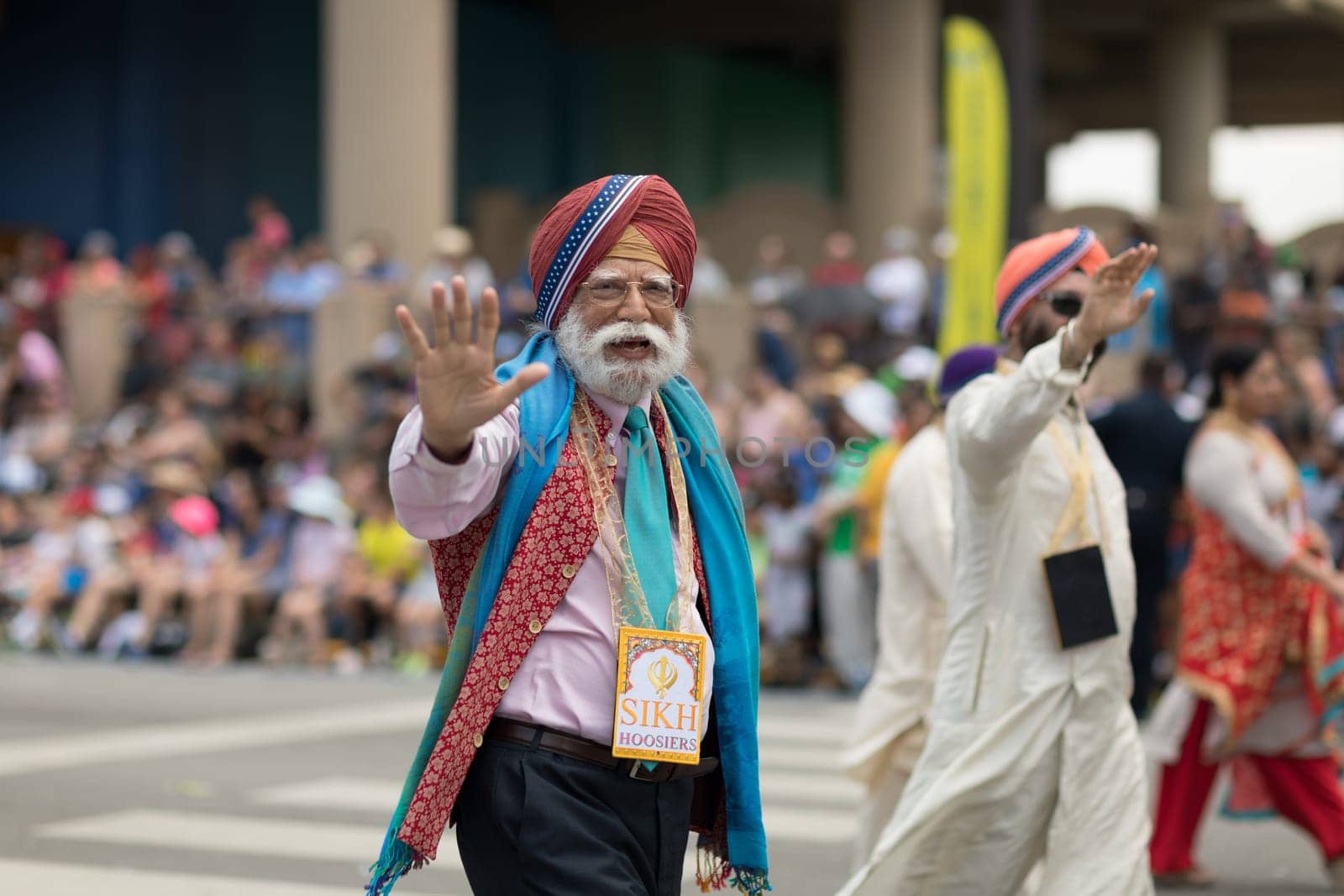 Indianapolis, Indiana, USA - May 26, 2018,  People from different countries with traditional clothing and carrying national flags at the Indy 500 Parade