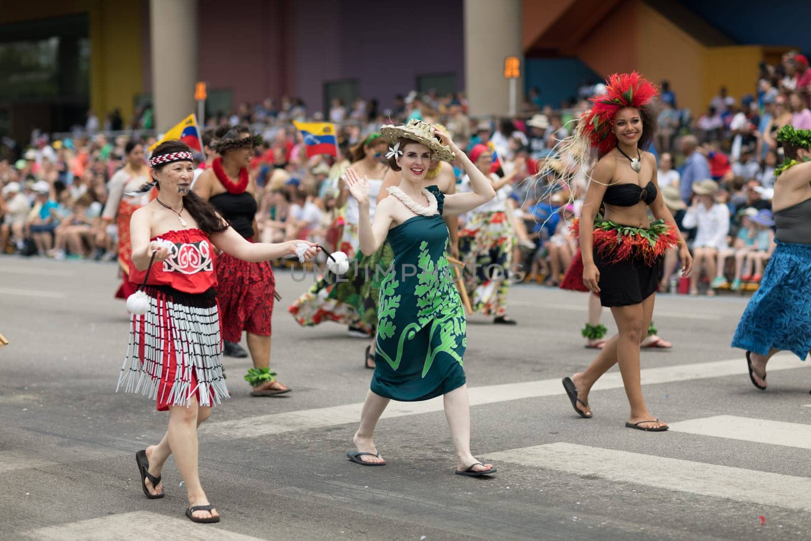 Indianapolis, Indiana, USA - May 26, 2018,  People from different countries with traditional clothing and carrying national flags at the Indy 500 Parade