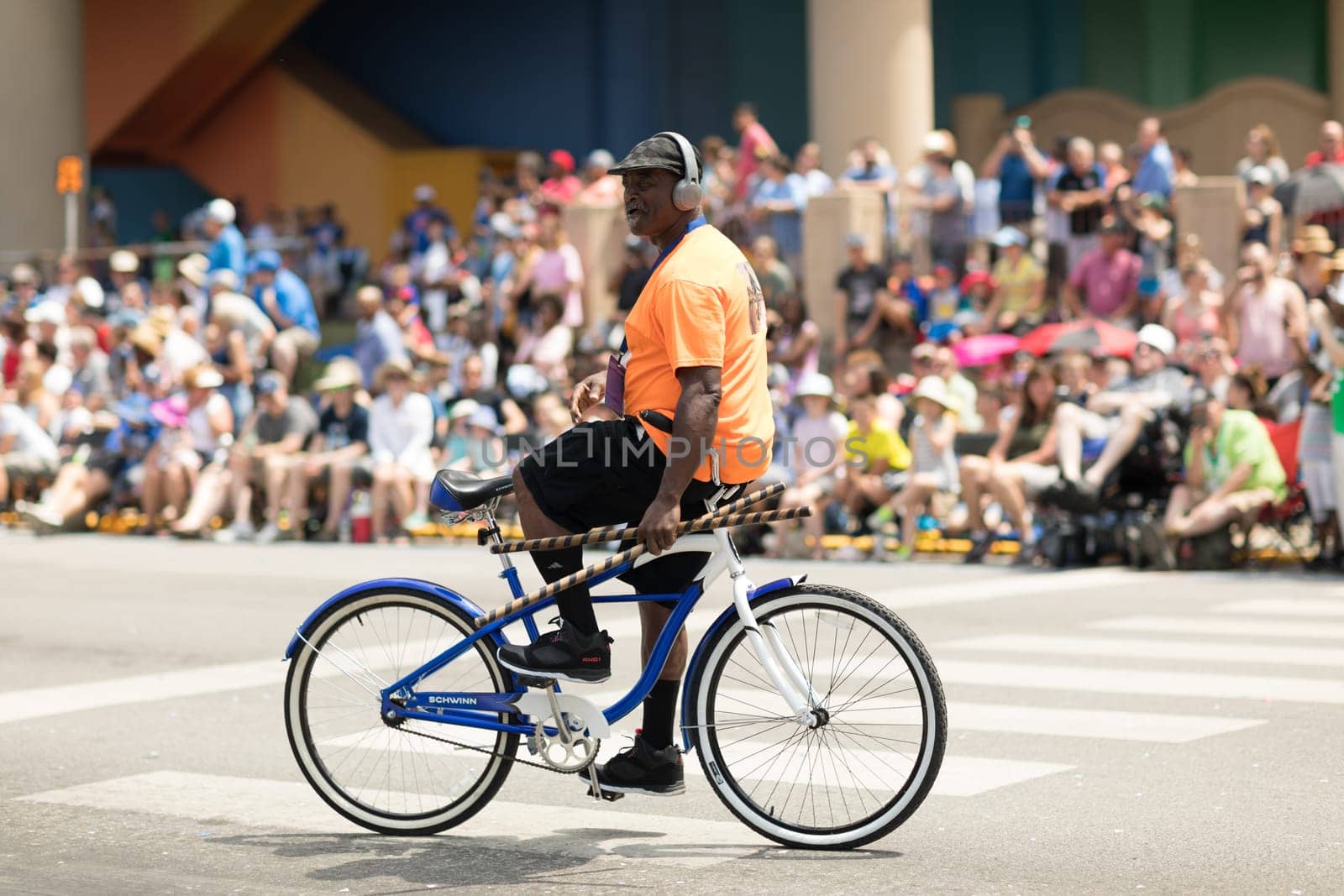 Indianapolis, Indiana, USA - May 26, 2018, An Afro American man doing stuns on his bicycle  at the Indy 500 Parade