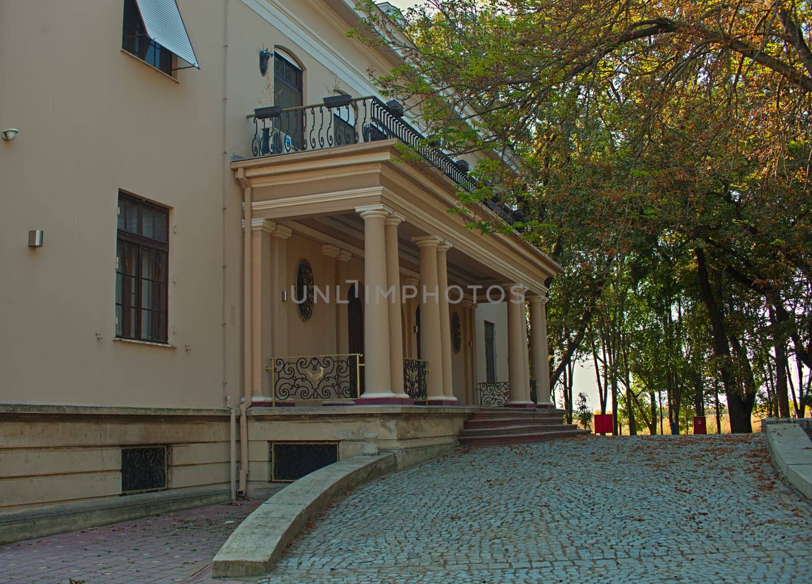 Outside view on entrance into villa with doors, stairs and windows