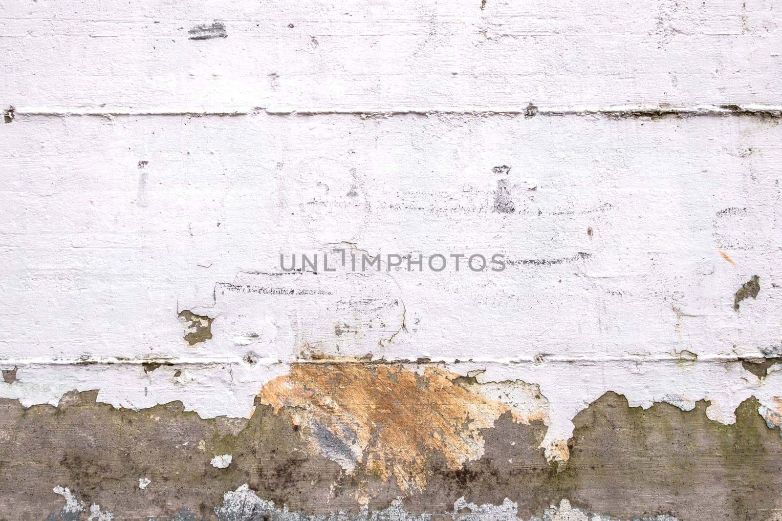 Background of rough wall painted white, ruined by the weather. Ideal for concepts and backgrounds.