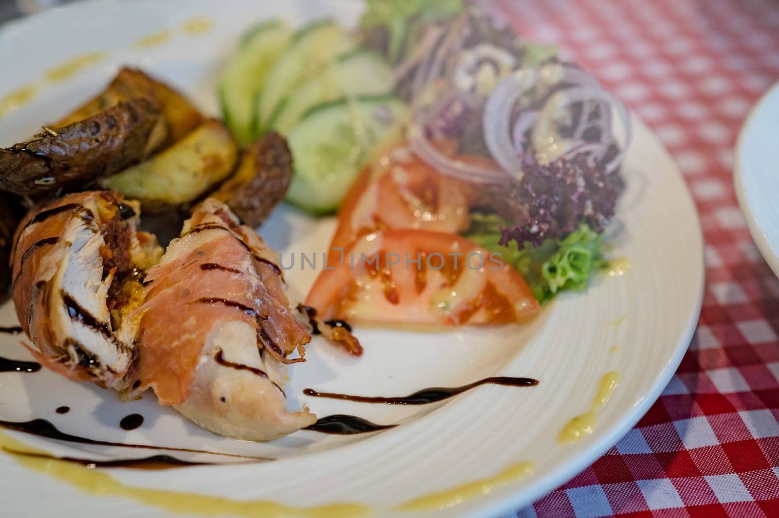 Grilled bacon and ham wrapped chicken breast,  served with summer salad and roast potatoes