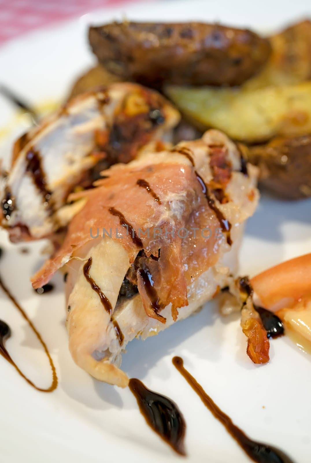 Grilled bacon and ham wrapped chicken breast,  served with summer salad and roast potatoes