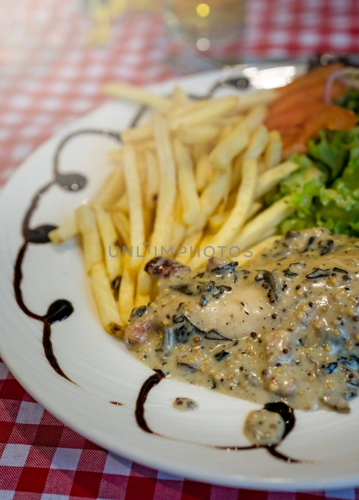 Grilled chicken breast with honey glazed mustard sauce meal served with summer salad and chips