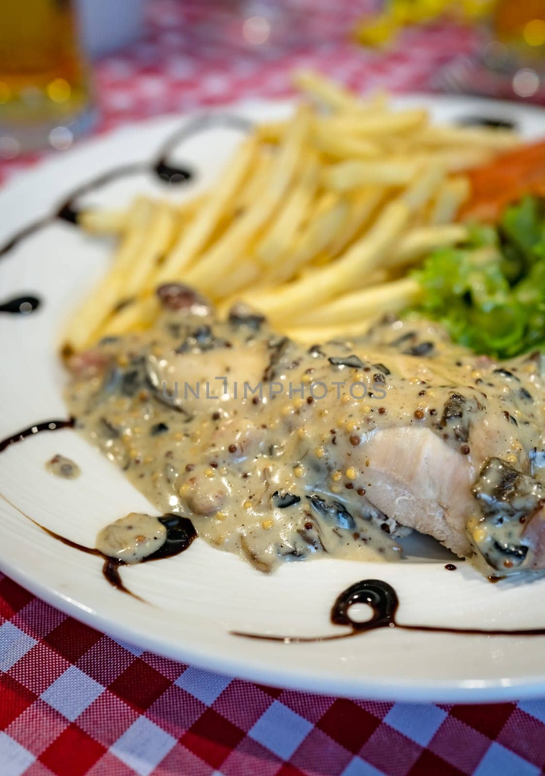 Grilled chicken breast with honey glazed mustard sauce meal served with summer salad and chips