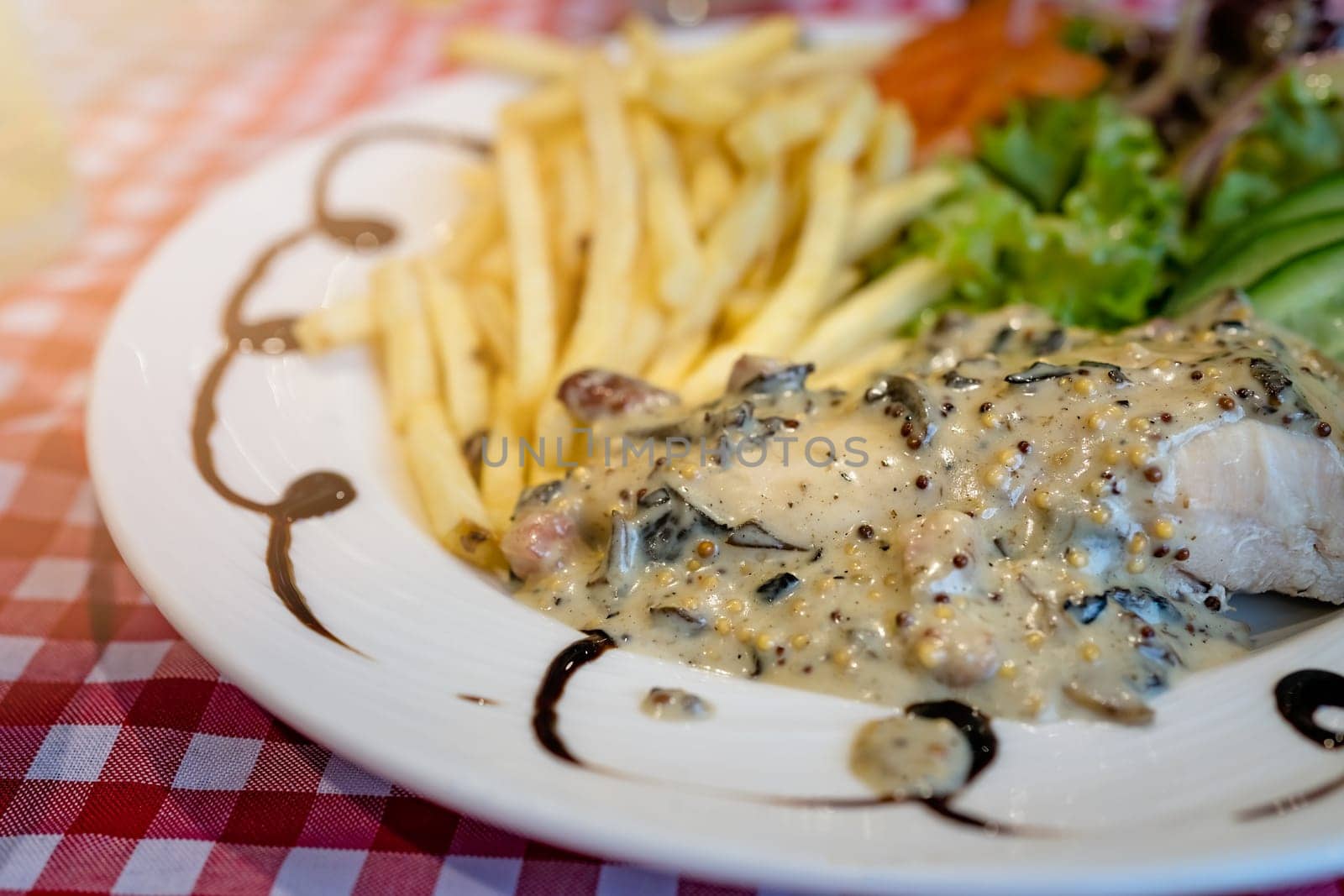 Grilled chicken breast with honey glazed mustard sauce meal served with summer salad and chips