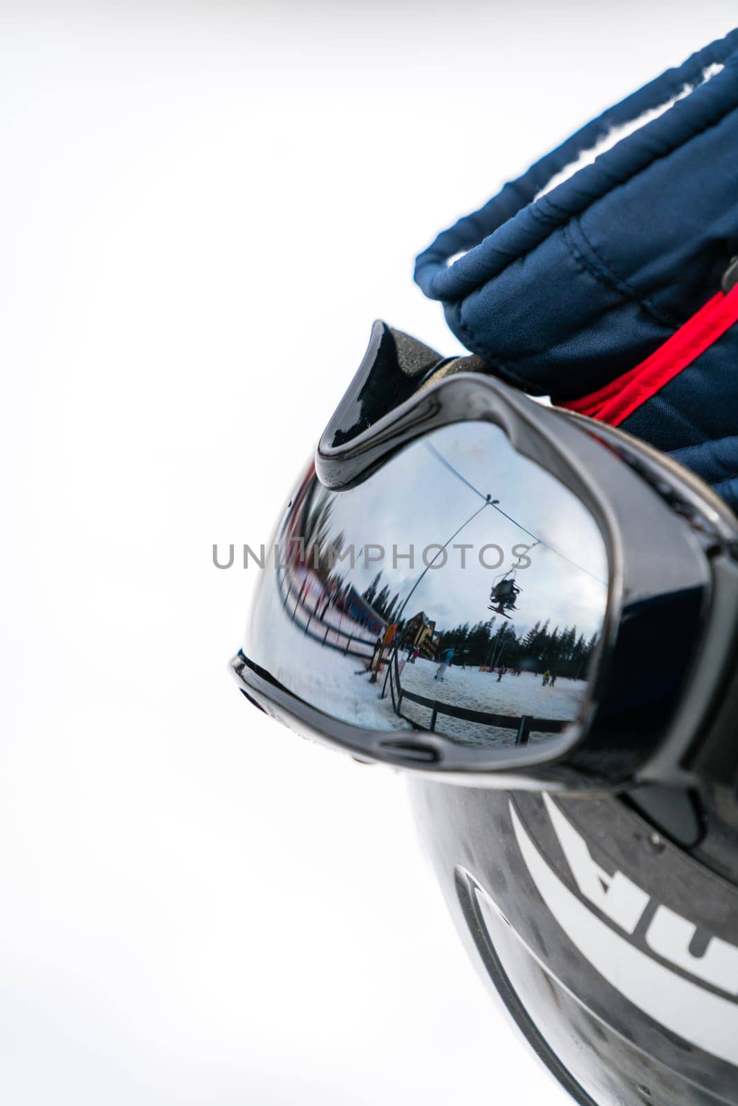 Ski helmet, gloves, googles and ski poles left in the snow on the mountain slope in winter