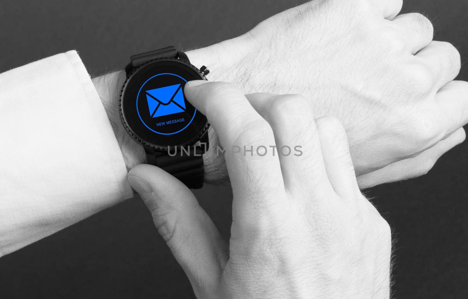 Black smartwatch isolated on a black background, new message