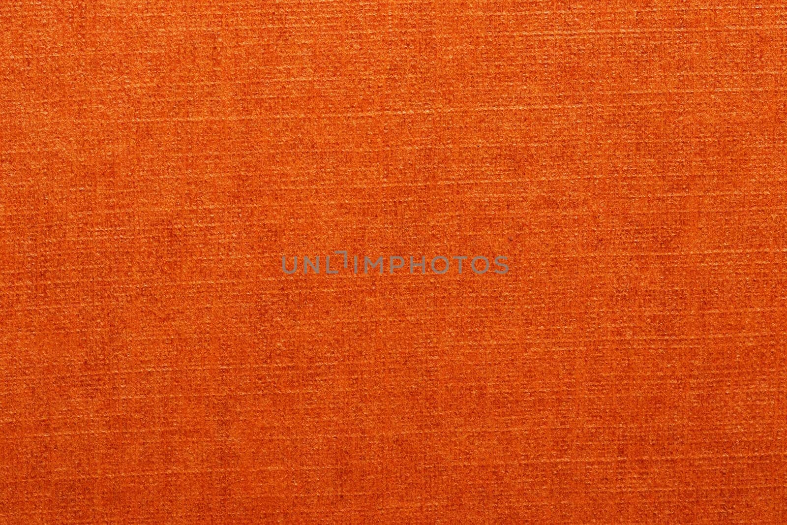 Orange texture. Closeup of a bright seamless orange paper or carton detail texture background for design and text. Macro.