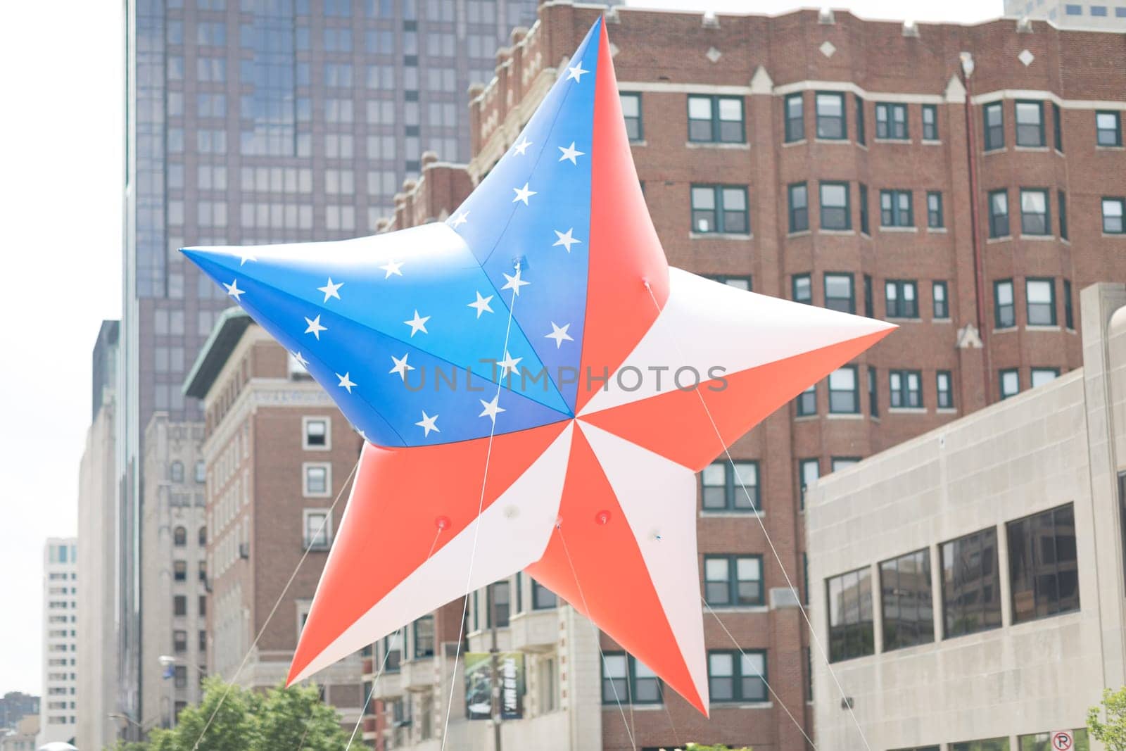 Indianapolis, Indiana, USA - May 26, 2018, Members of the Gold Star Families of Indiana carry a giant balloon in shape of a star with the colors of the American Flag at the Indy 500 Parade
