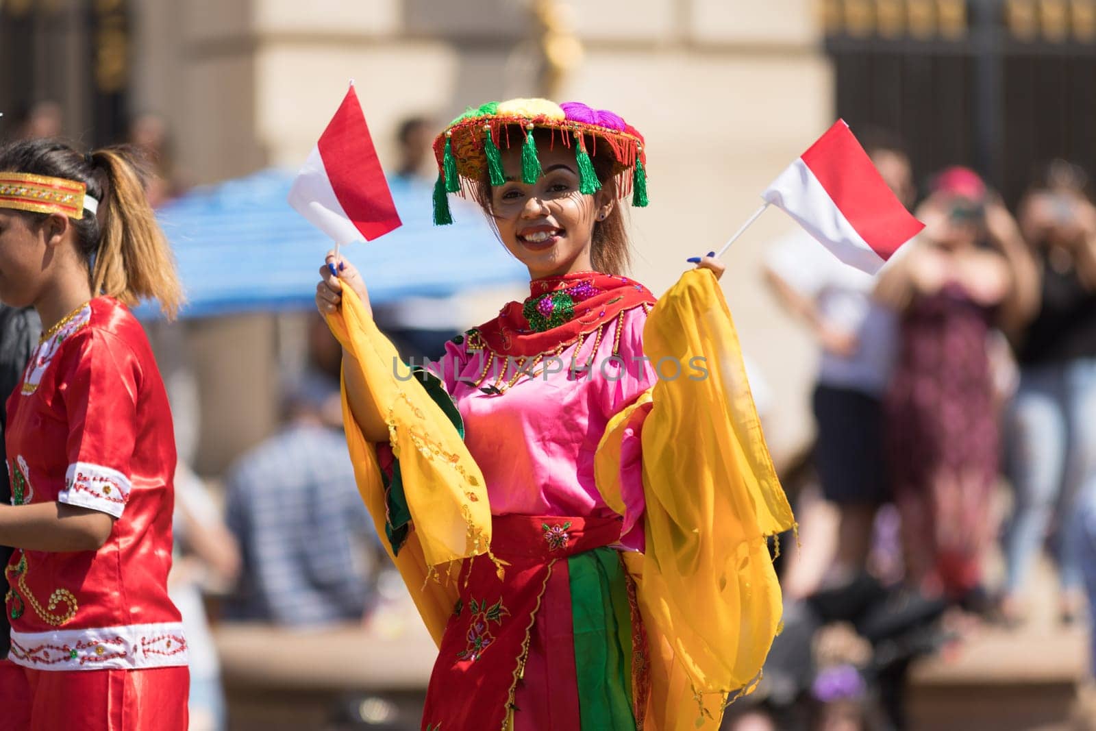 Washington, D.C., USA - April 14, 2018 People from Indonesia wearing traditional clothing walking down the street in the 2018 National Cherry Blossom Parade
