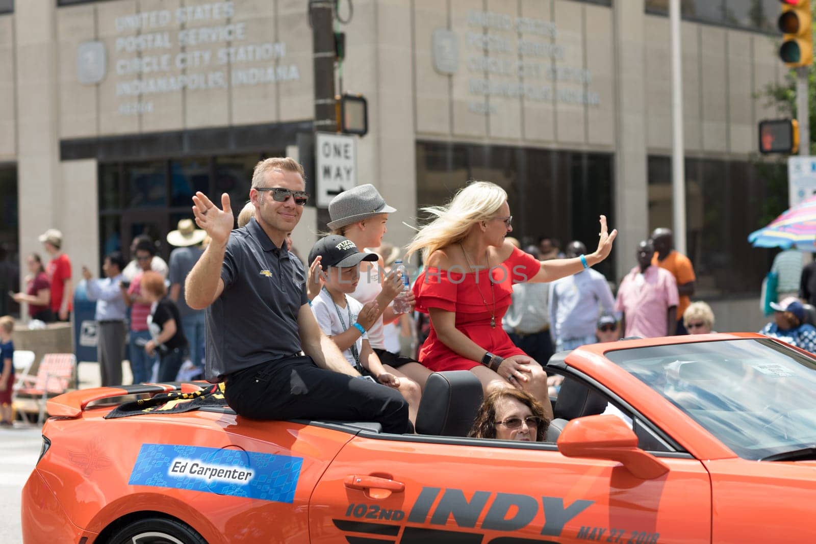 Indianapolis, Indiana, USA - May 26, 2018, Indycar driver Ed Carpenter and his family on a car going down the road at the Indy 500 Parade