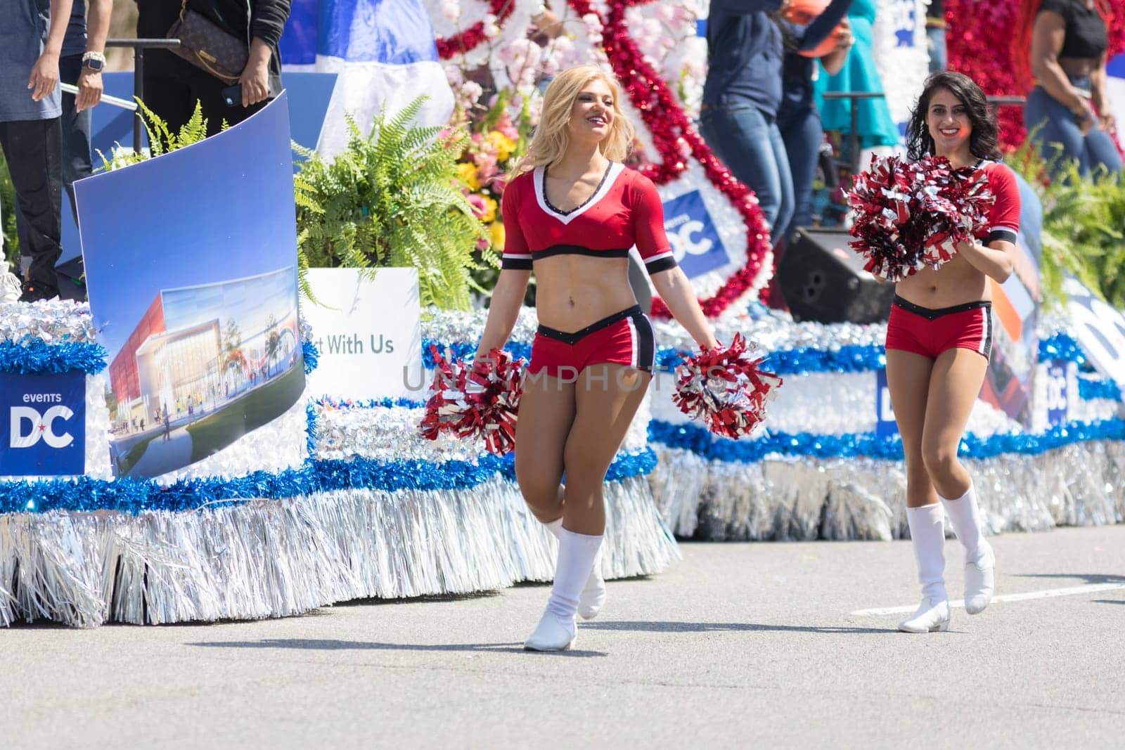 Washington, D.C., USA - April 14, 2018 Cheerleader dancing while walking down the street in the 2018 National Cherry Blossom Parade