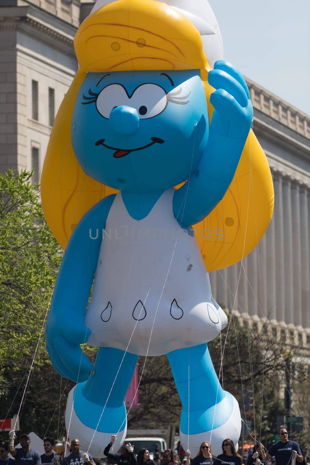 Washington, D.C., USA - April 14, 2018 A balloon in shape of Smurfette going down the road in the 2018 National Cherry Blossom Parade