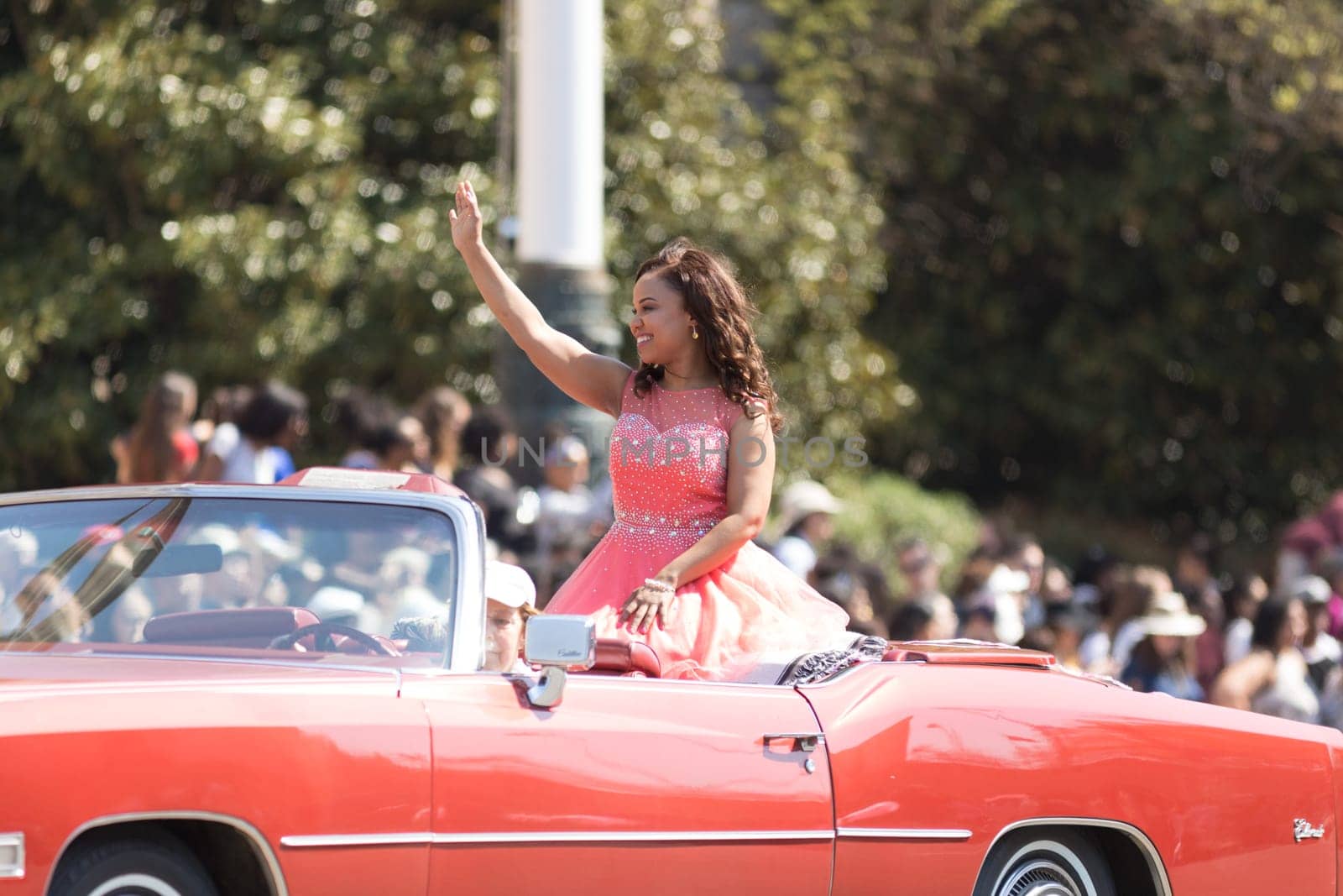 Washington, D.C., USA - April 14, 2018 Lady on a classic car going down the road  in the 2018 National Cherry Blossom Parade