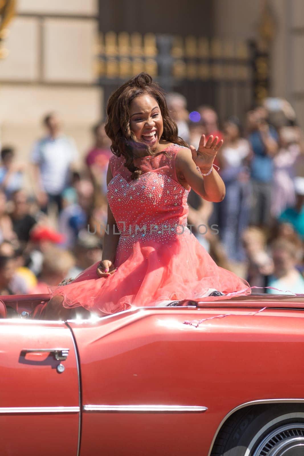 Washington, D.C., USA - April 14, 2018 Lady on a classic car going down the road  in the 2018 National Cherry Blossom Parade