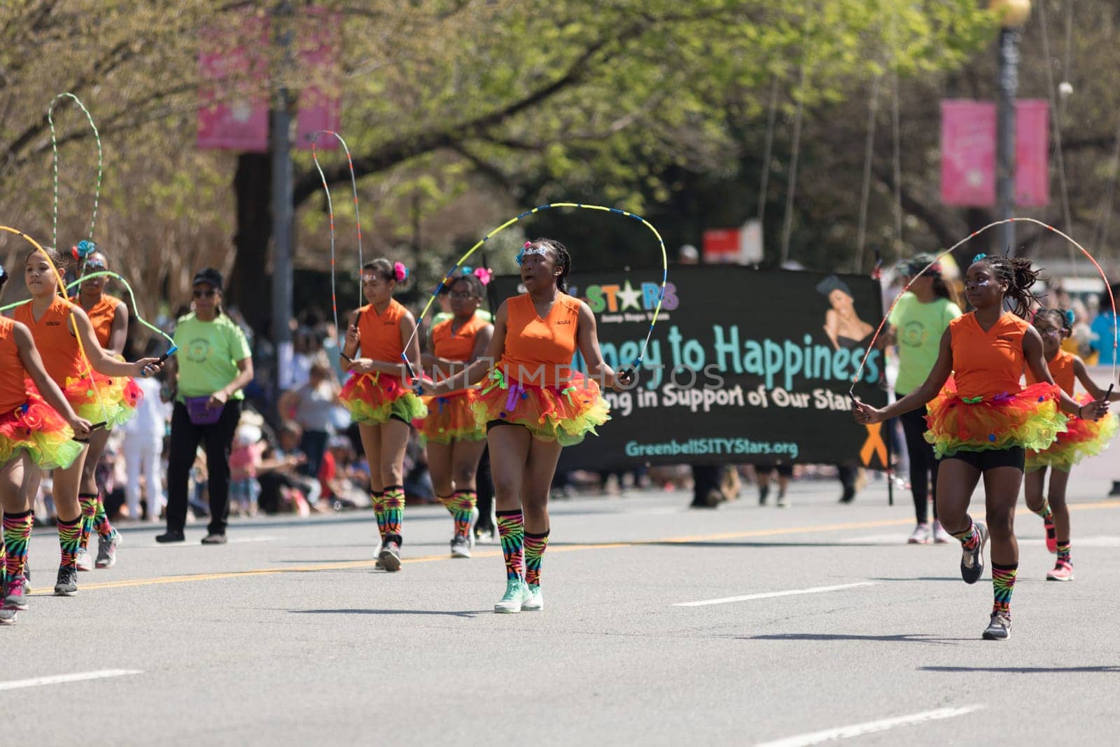 Washington, D.C., USA - April 14, 2018 Students wearing colorful skirts jumping ropes  in the 2018 National Cherry Blossom Parade