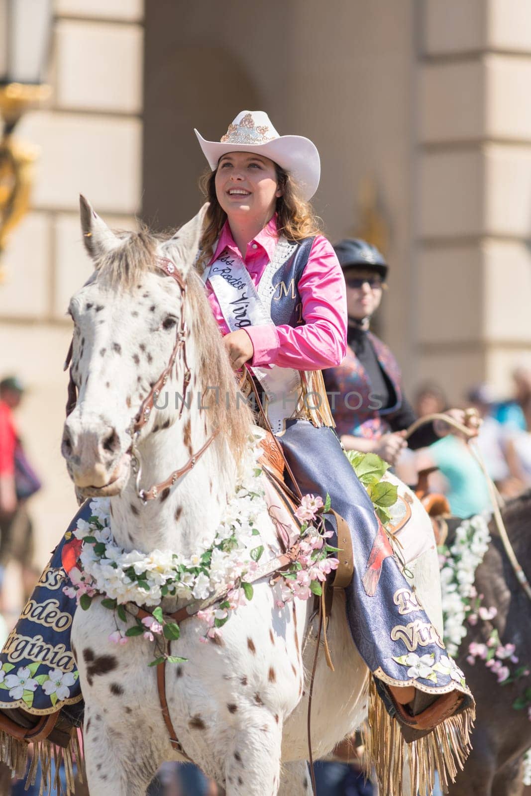 Washington, D.C., USA - April 14, 2018 A woman riding a horse covered in cherry flowers in the 2018 National Cherry Blossom Parade