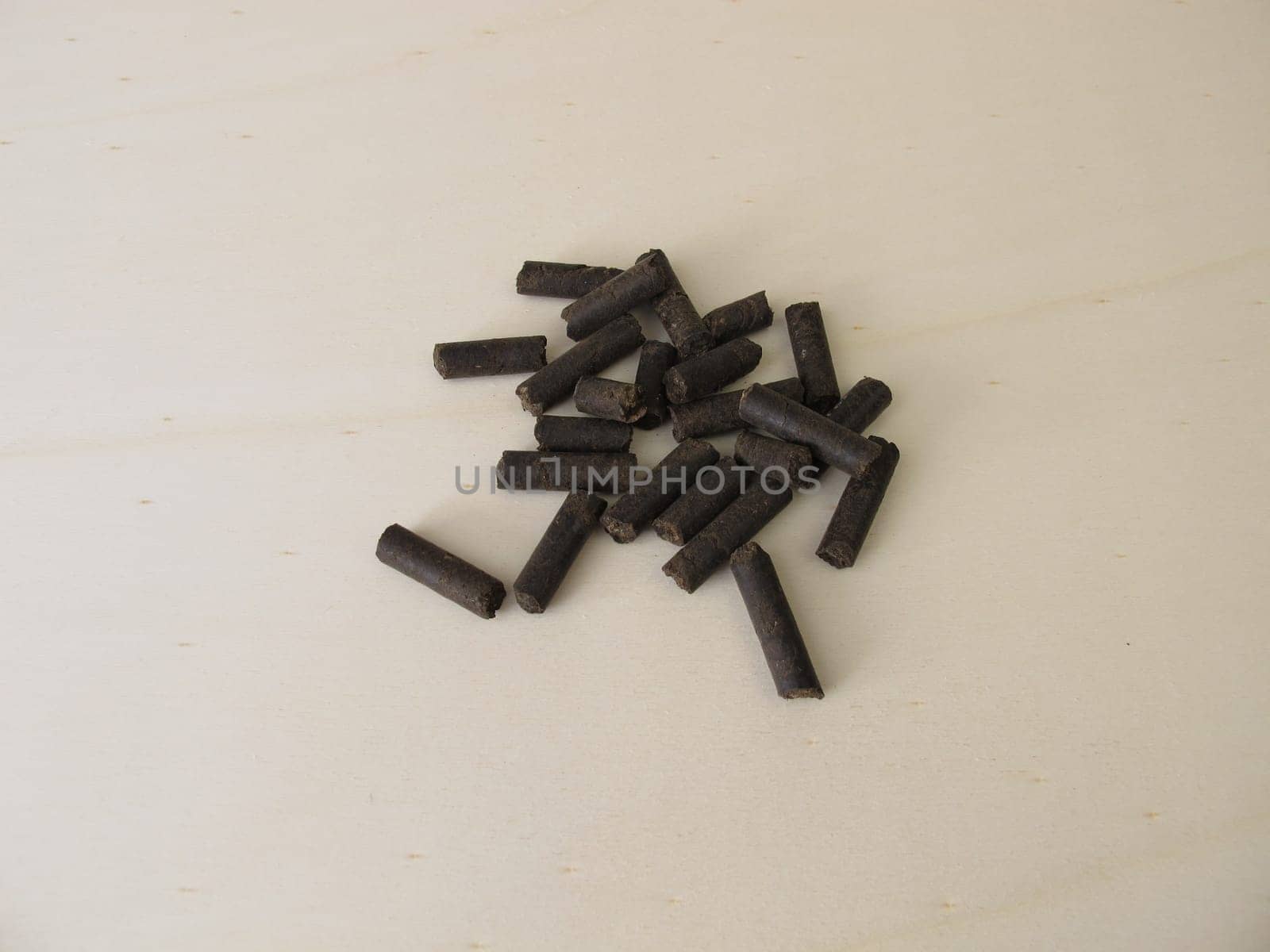 Horse manure pellets for fertilizing on wooden board