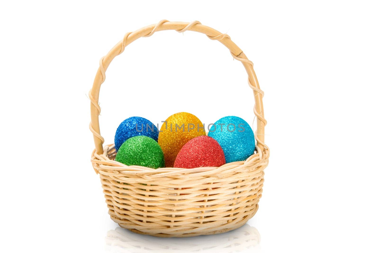 Colorful easter eggs with glitter on wooden basket isolated over white background. Happy Easter