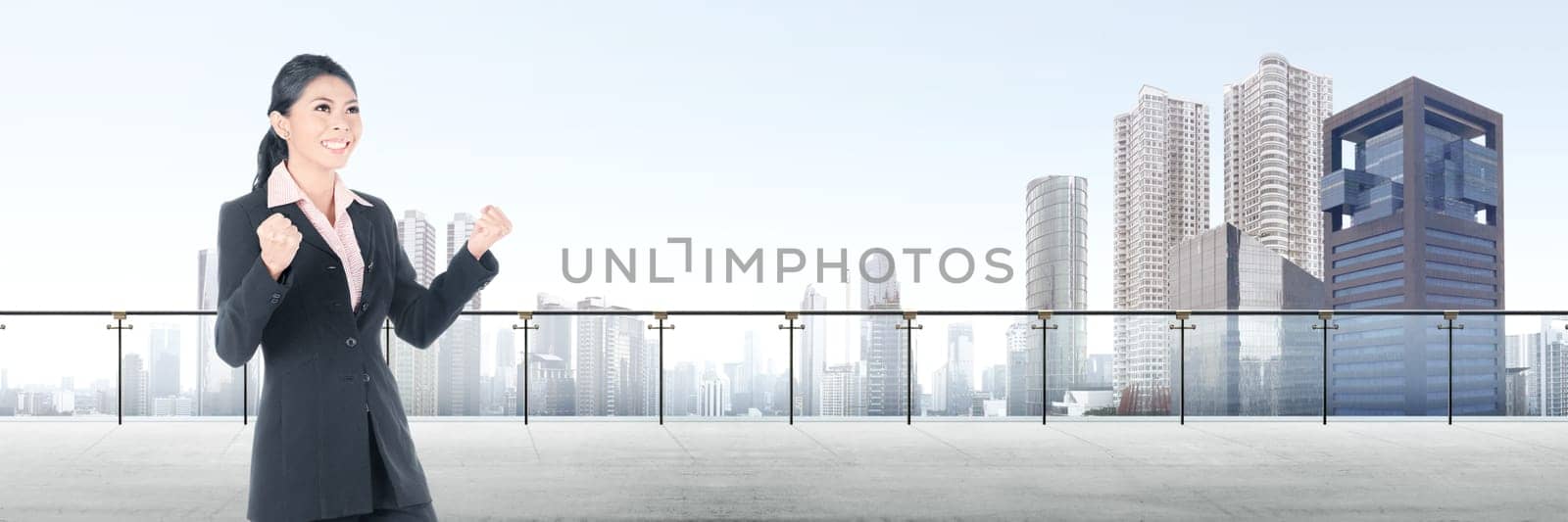 Successful asian business woman standing on modern terrace with cityscapes background