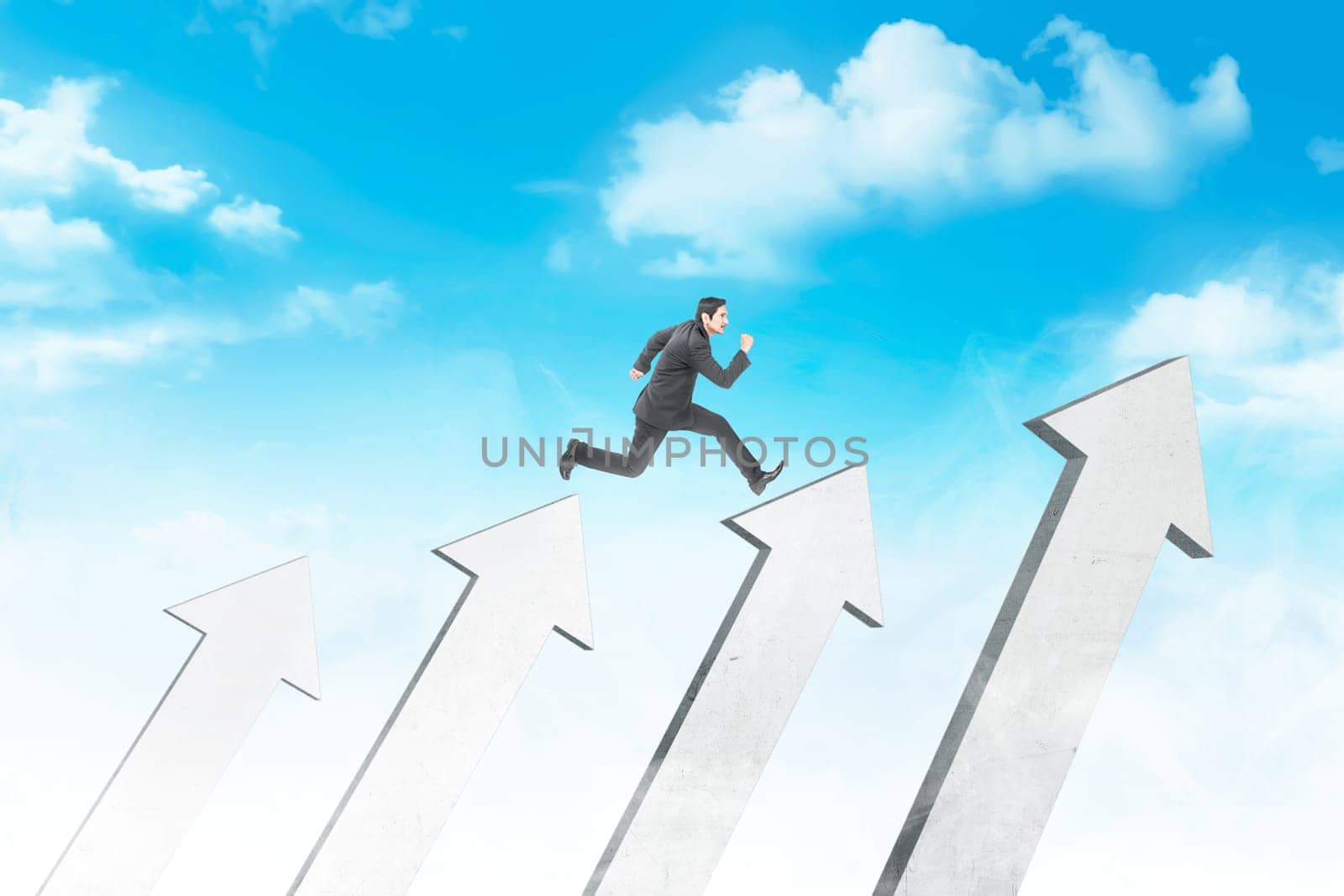 Attractive asian businessman jumping above white arrows with blue sky background. Business concept