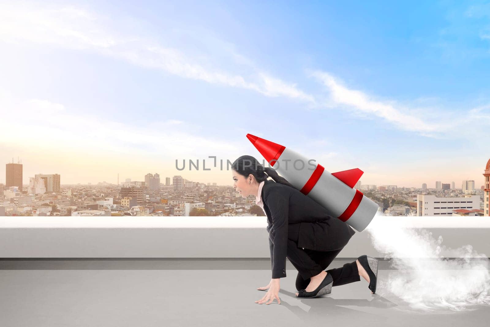 Excited asian business woman on the rooftop with rocket ready to fly. Business concept