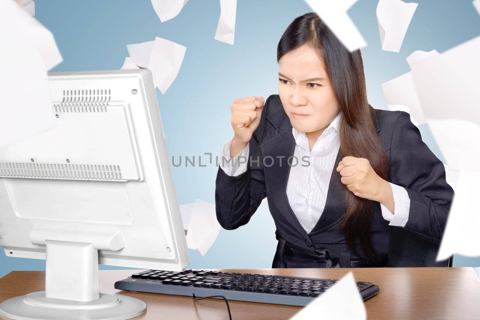 Upset asian business woman when working with flying paper scattered on the office room