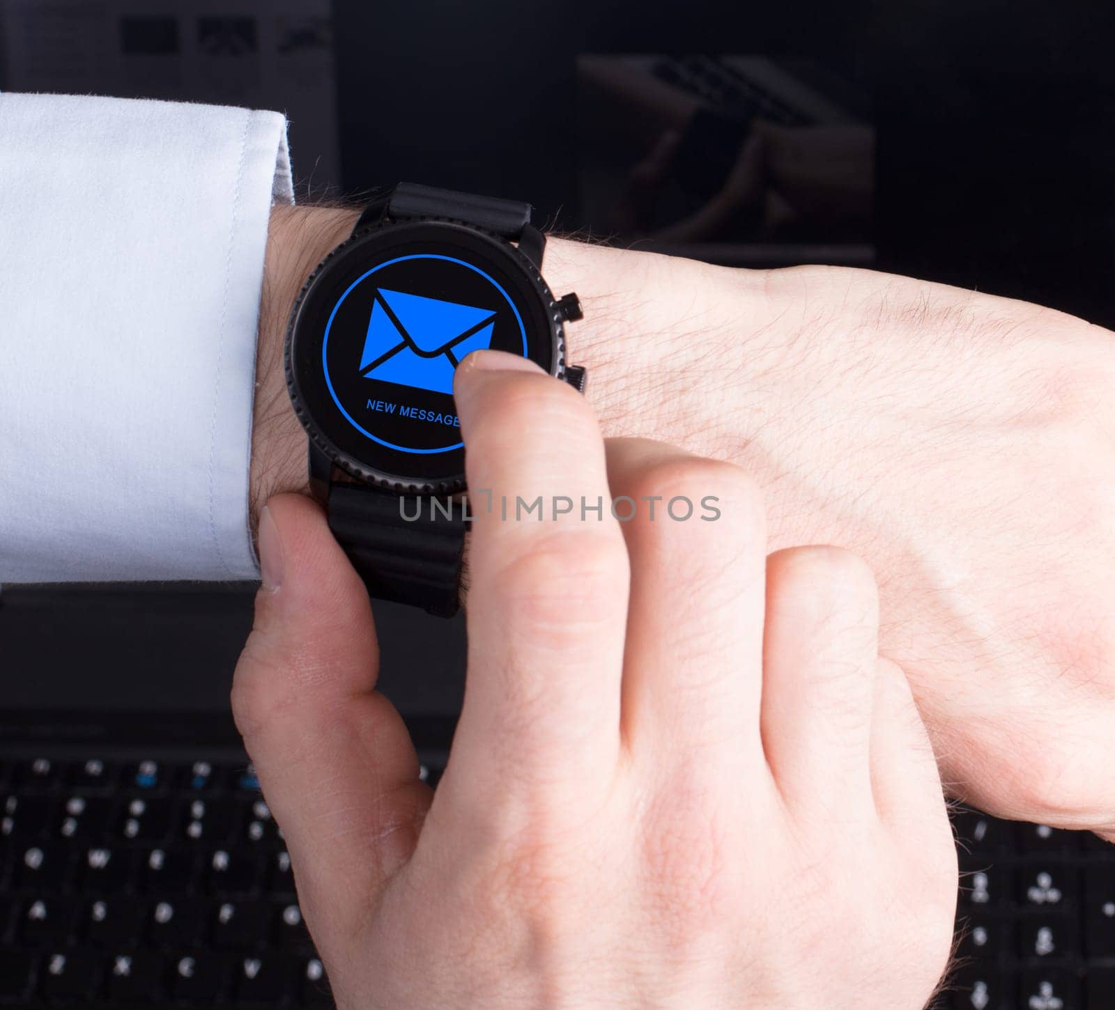 Black smartwatch isolated on a black background, new message