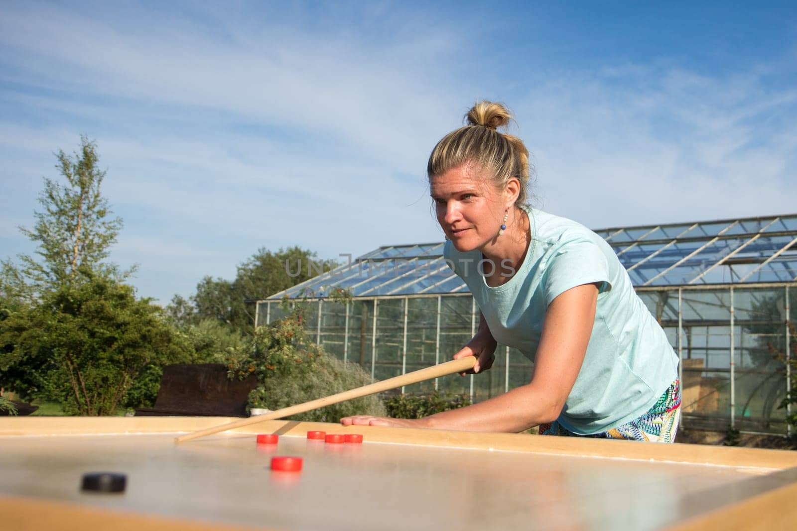 Women playing Novuss in outdoors. Novuss is a national sport in Latvia similar to pocket billiards or pool.