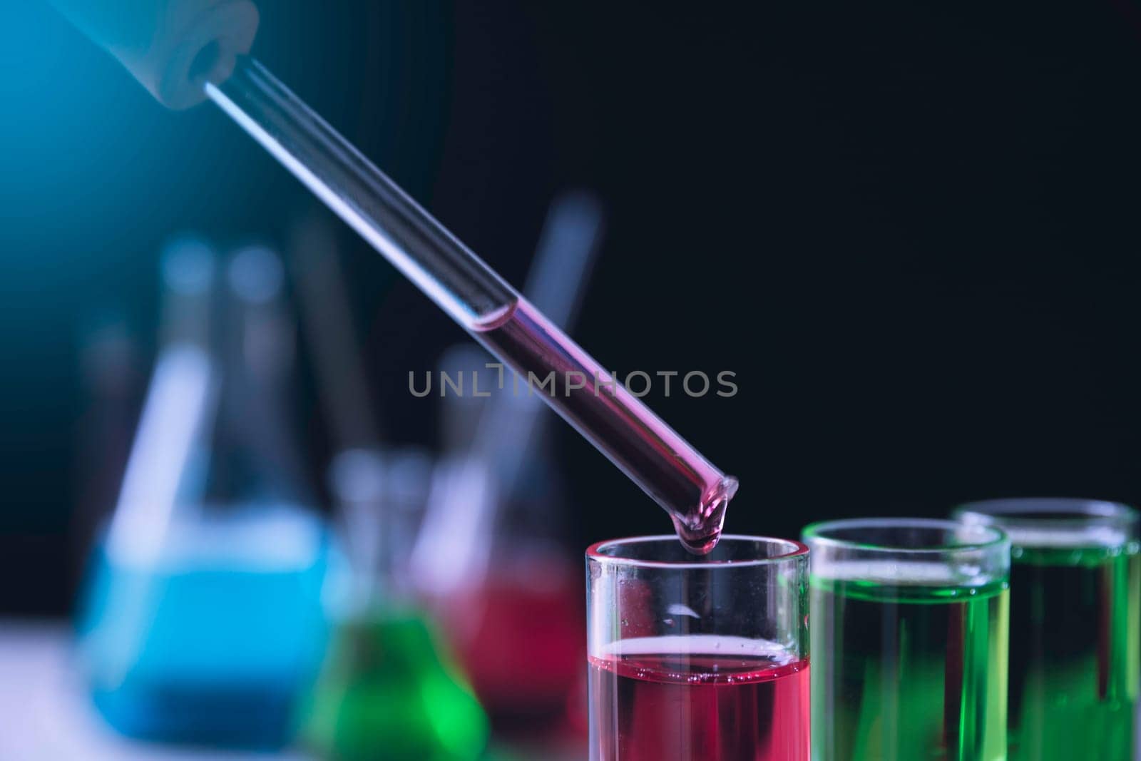 Researcher with glass laboratory chemical test tubes with liquid for analytical , medical, pharmaceutical and scientific research concept.