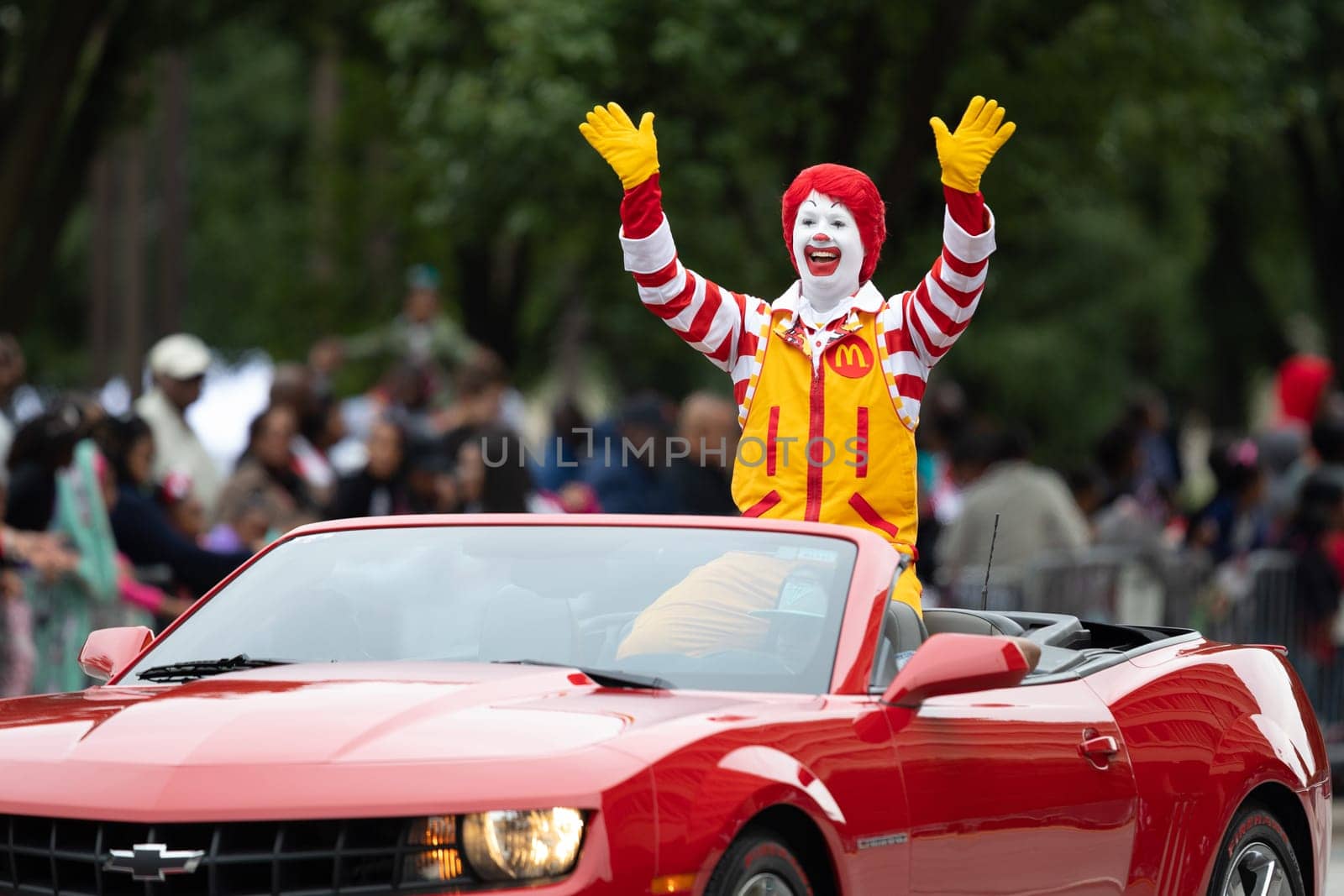 Indianapolis, Indiana, USA - September 22, 2018: The Circle City Classic Parade, Ronald McDonald waving at spectators while going on a camaro down the road