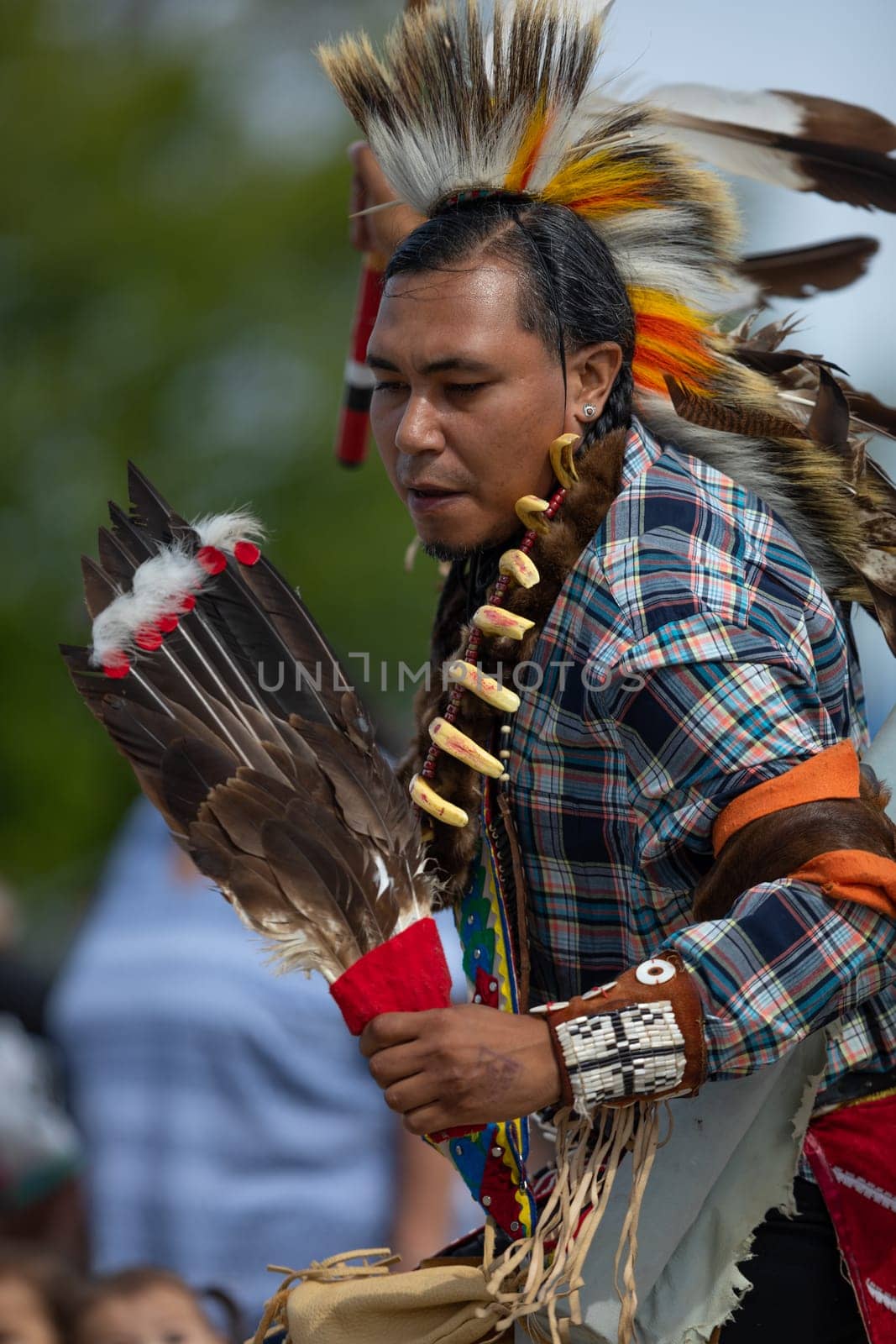 Milwaukee, Wisconsin, USA - September 8, 2018 The Indian Summer Festival, Man wearing traditional native american clothing, dancing at the pow wow competition.