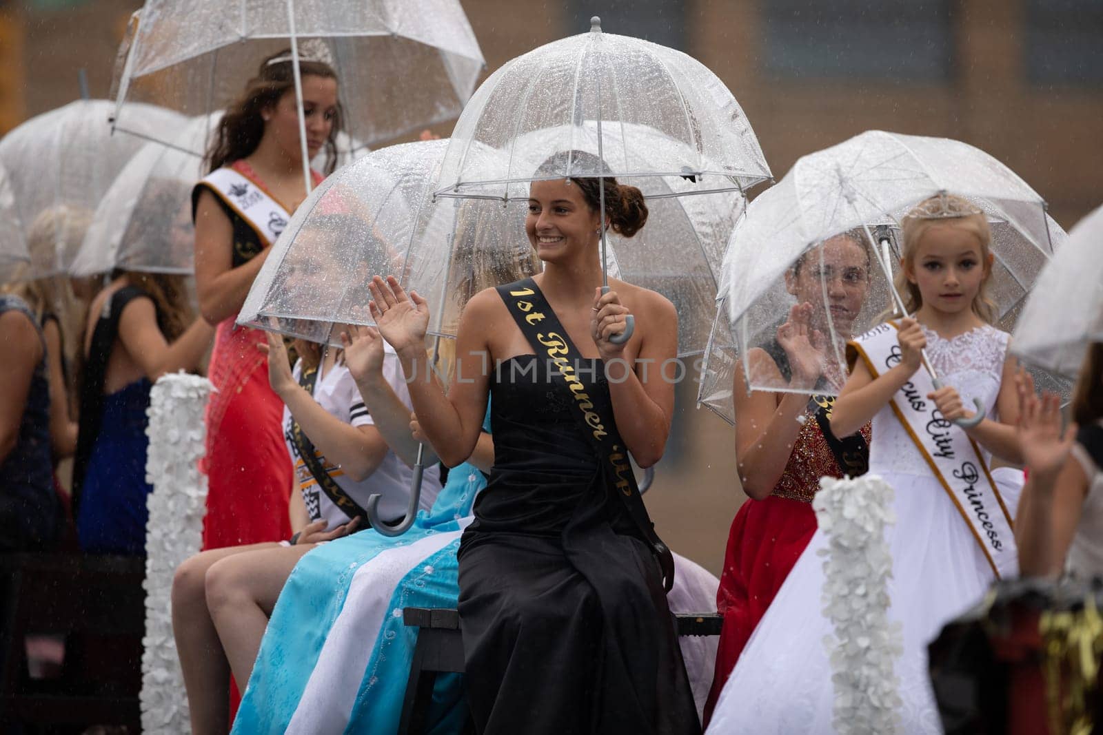 Peru, Indiana, USA - July 21, 2018 Under heavy rain The Beauty queens going down the road at the Circus City Festival Parade