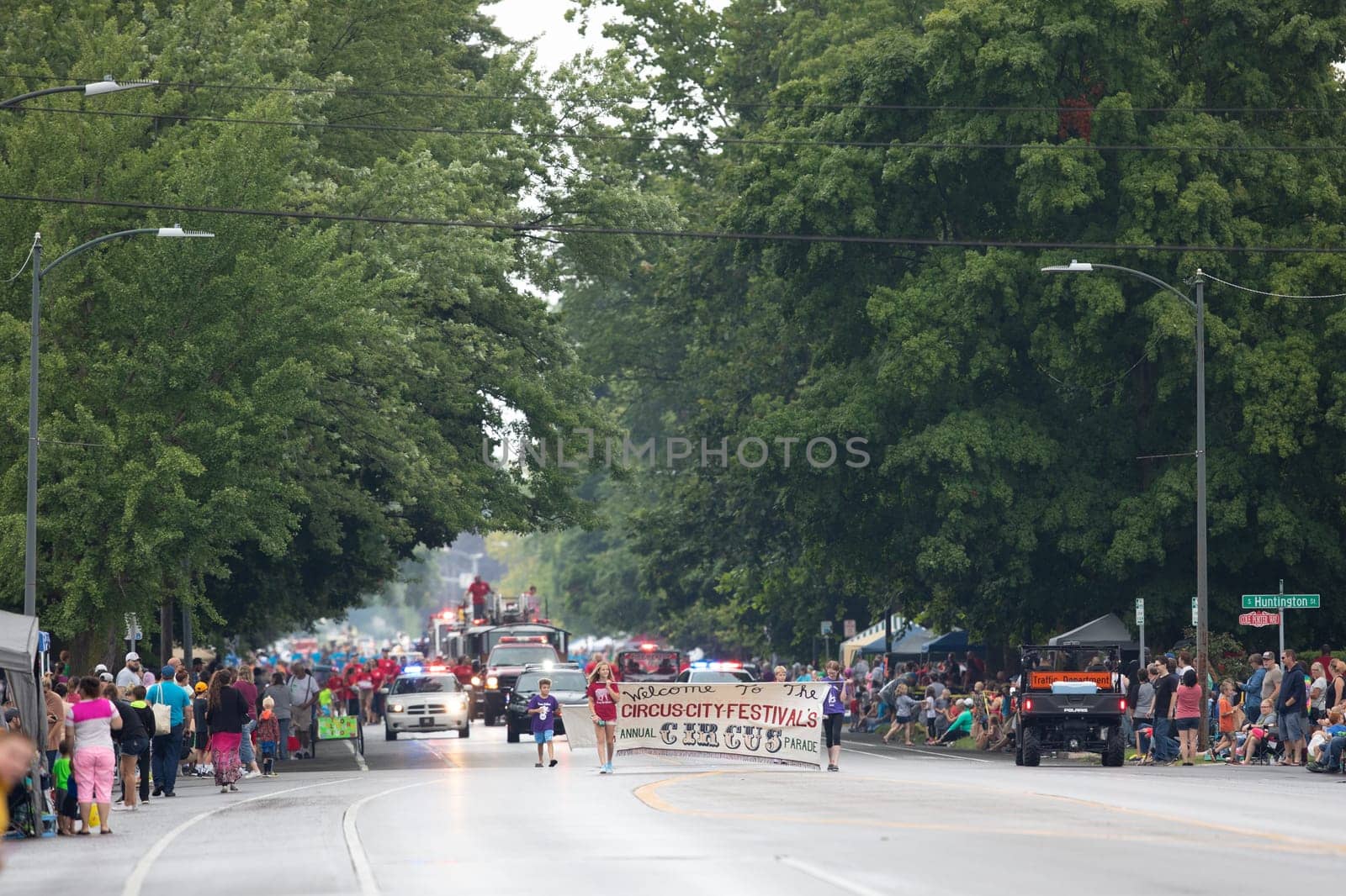 Peru, Indiana, USA - July 21, 2018 Children carry a banner that says Welcome to the Circus-City Festival's Annual Circus Parade at the Circus City Festival Parade