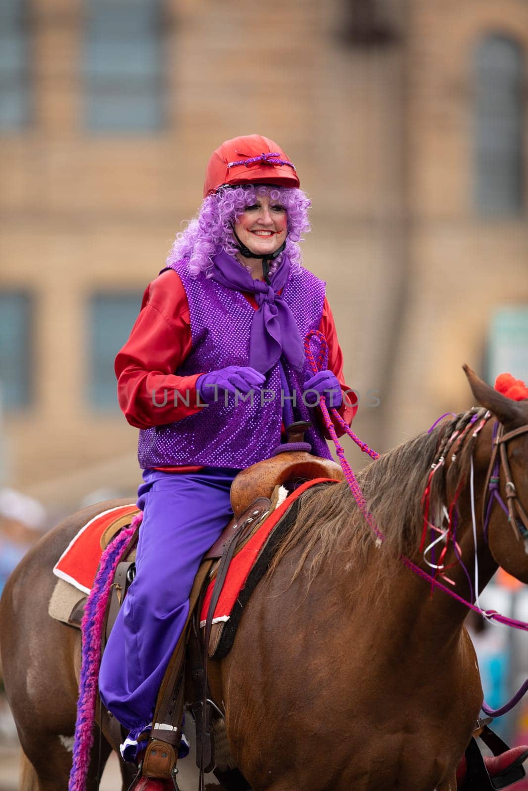 Peru, Indiana, USA - July 21, 2018 Woman dress up as a clown riding a horse at the Circus City Festival Parade