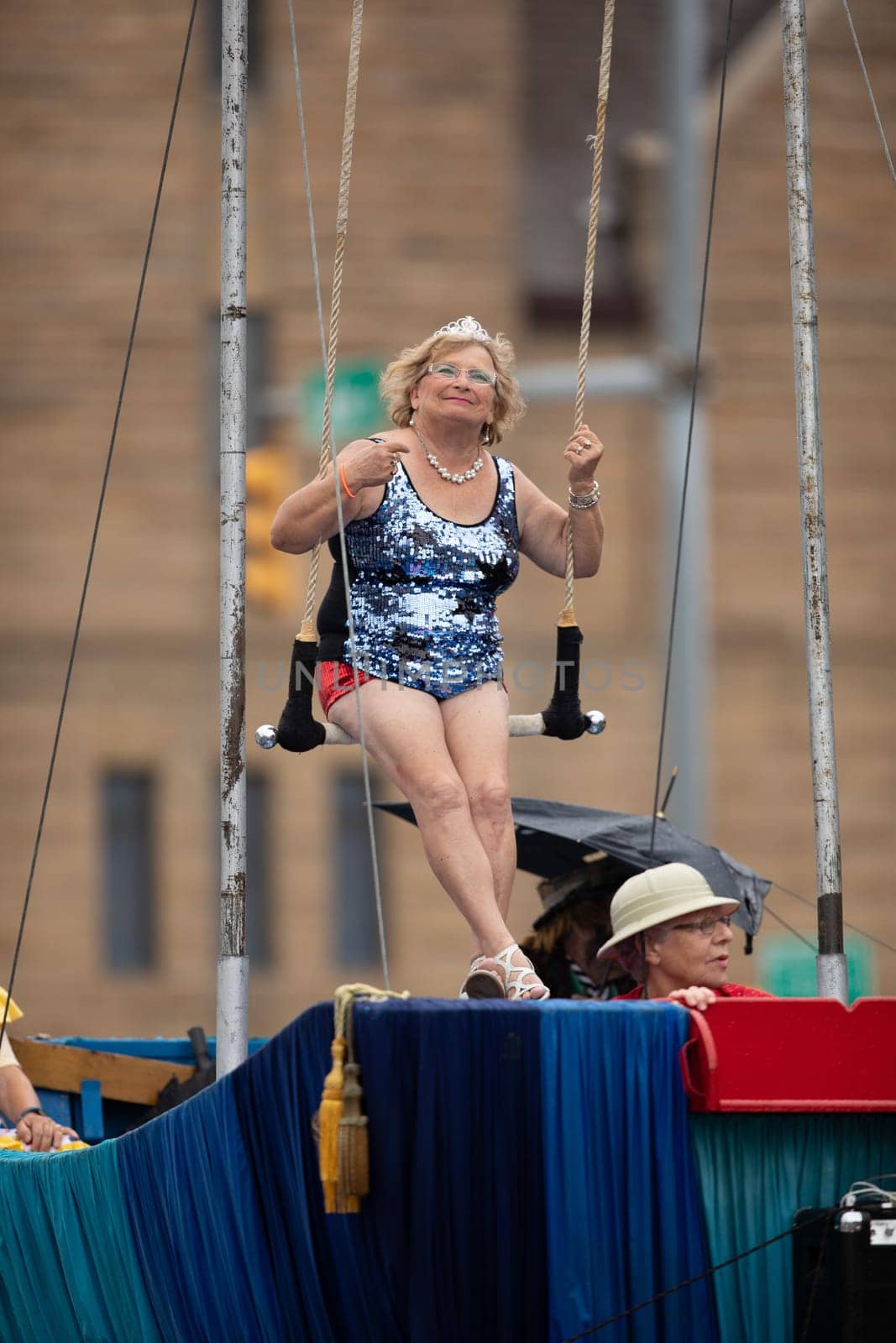 Peru, Indiana, USA - July 21, 2018 Older woman wearing  circus outfit on a float wearing a beauty crown at the Circus City Festival Parade