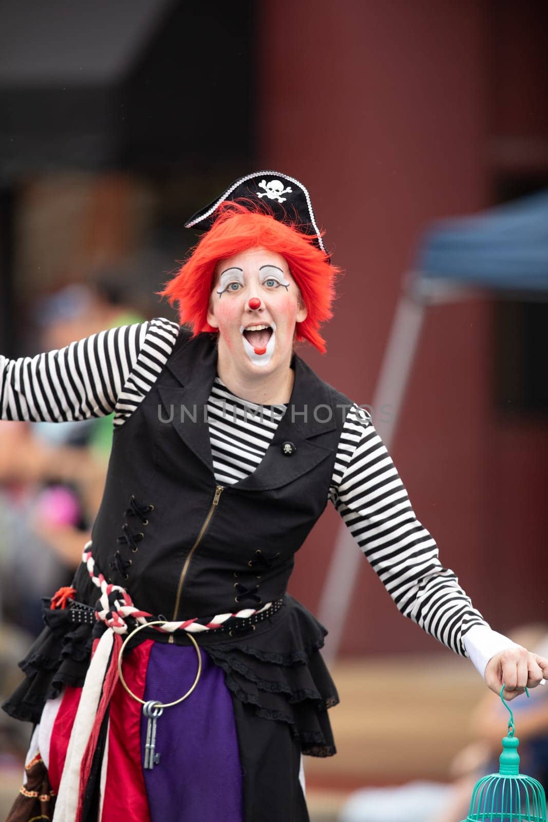 Peru, Indiana, USA - July 21, 2018 Woman wearing a clown outfit at the Circus City Festival Parade