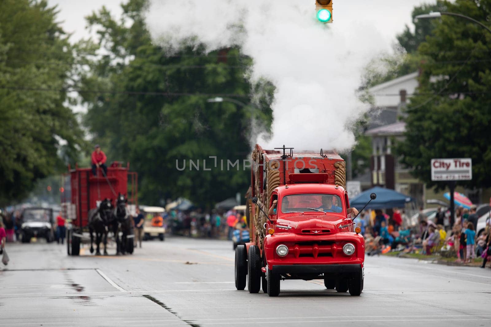 Peru, Indiana, USA - July 21, 2018 Old classic red turck creating steam going down the road at the Circus City Festival Parade