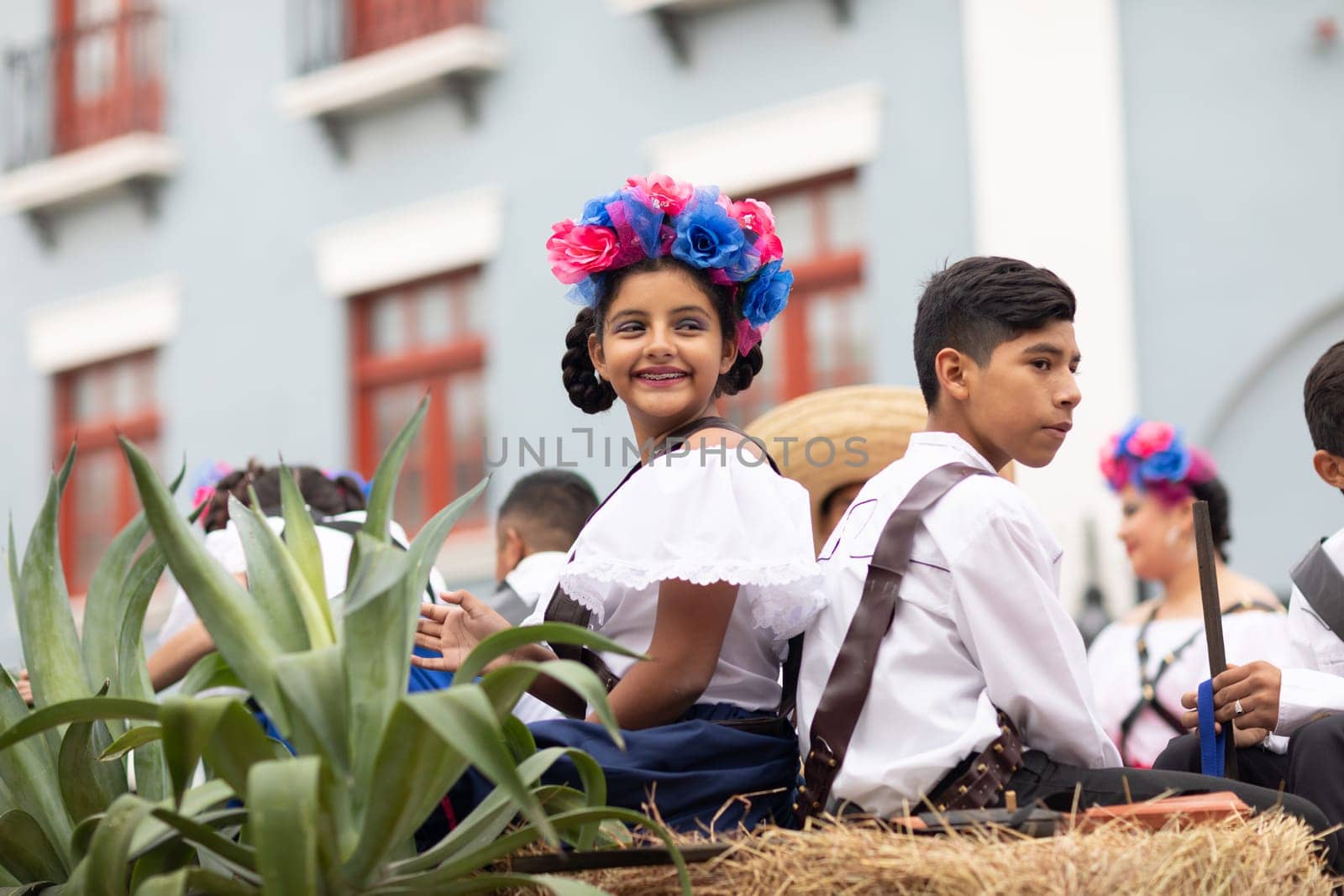 Matamoros, Tamaulipas, Mexico - November 20, 2018: The November 20 Parade, Young girl and boy wearing traditional mexican clothing going down the street on a float