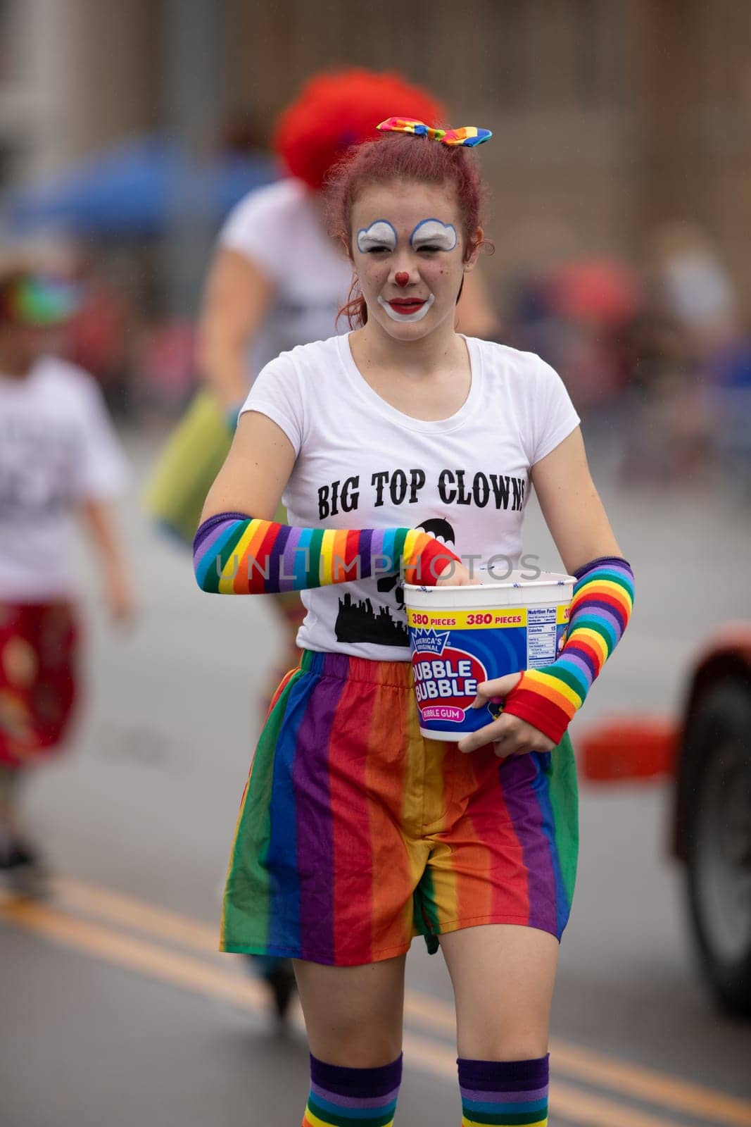 Peru, Indiana, USA - July 21, 2018 Men women and children dress up as clowns going down the road at the Circus City Festival Parade