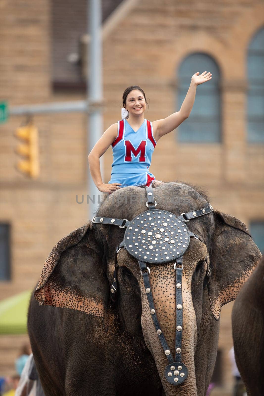 Peru, Indiana, USA - July 21, 2018 Young women riding elephants down the road at the Circus City Festival Parade