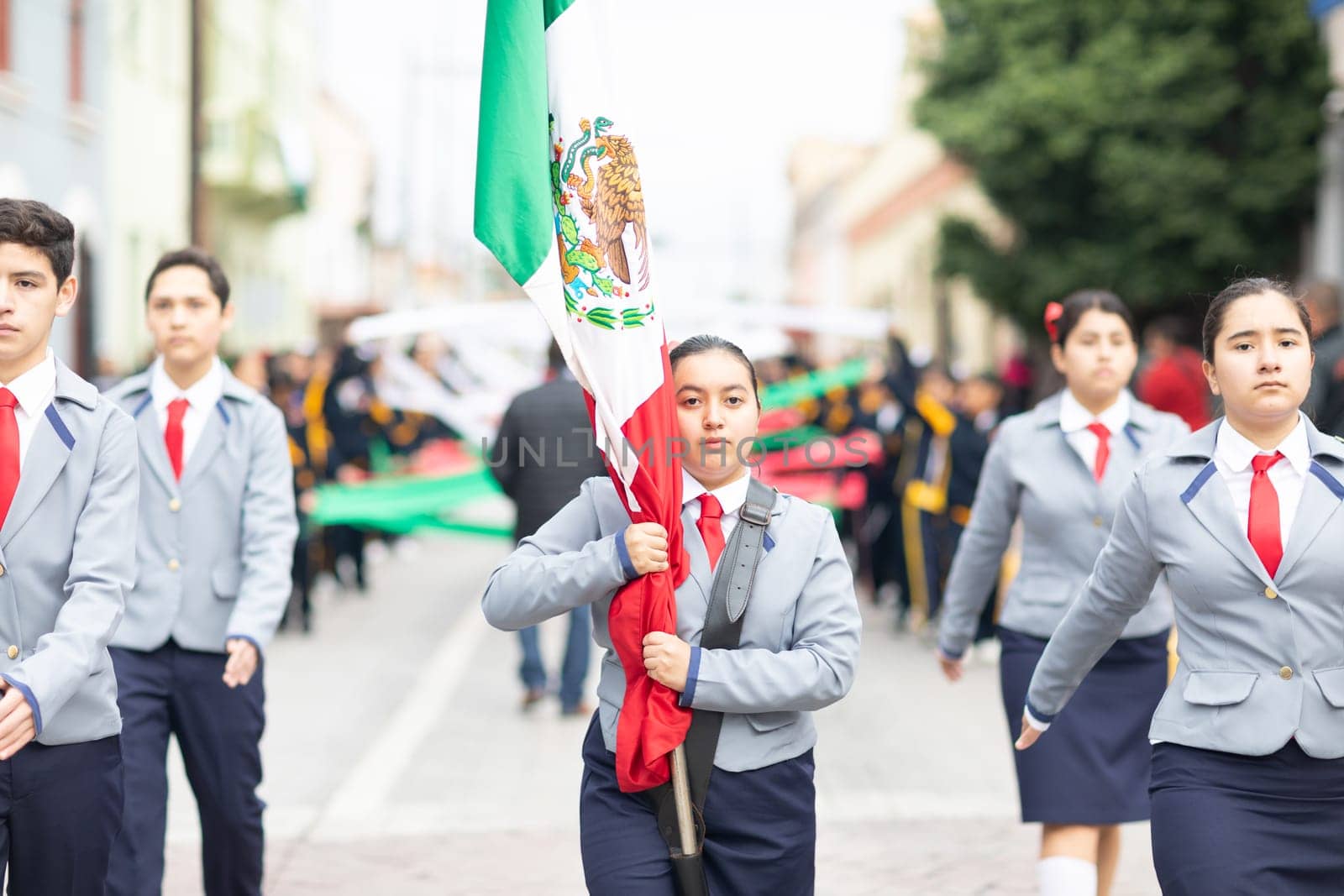 Matamoros, Tamaulipas, Mexico - November 20, 2018: The November 20 Parade, The Mexican Flag being scorted by students at the parade