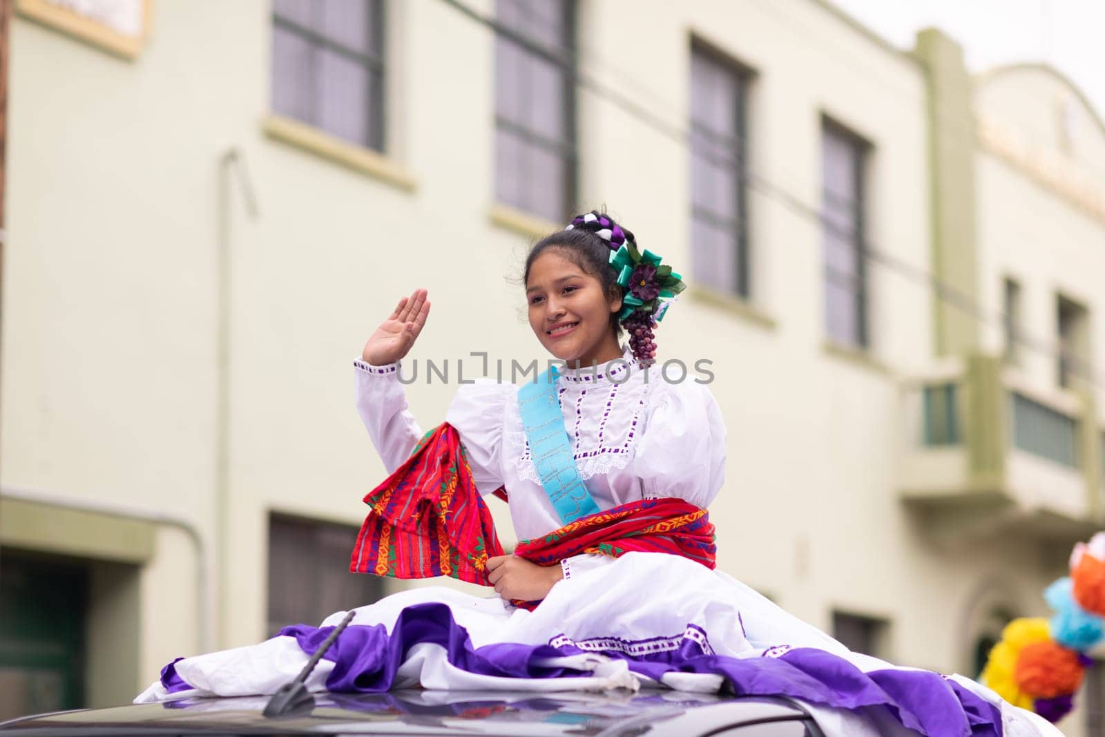 Matamoros, Tamaulipas, Mexico - November 20, 2018: The November 20 Parade, Young Mexican woman wearing traditional mexican clothing going down the road during the parade